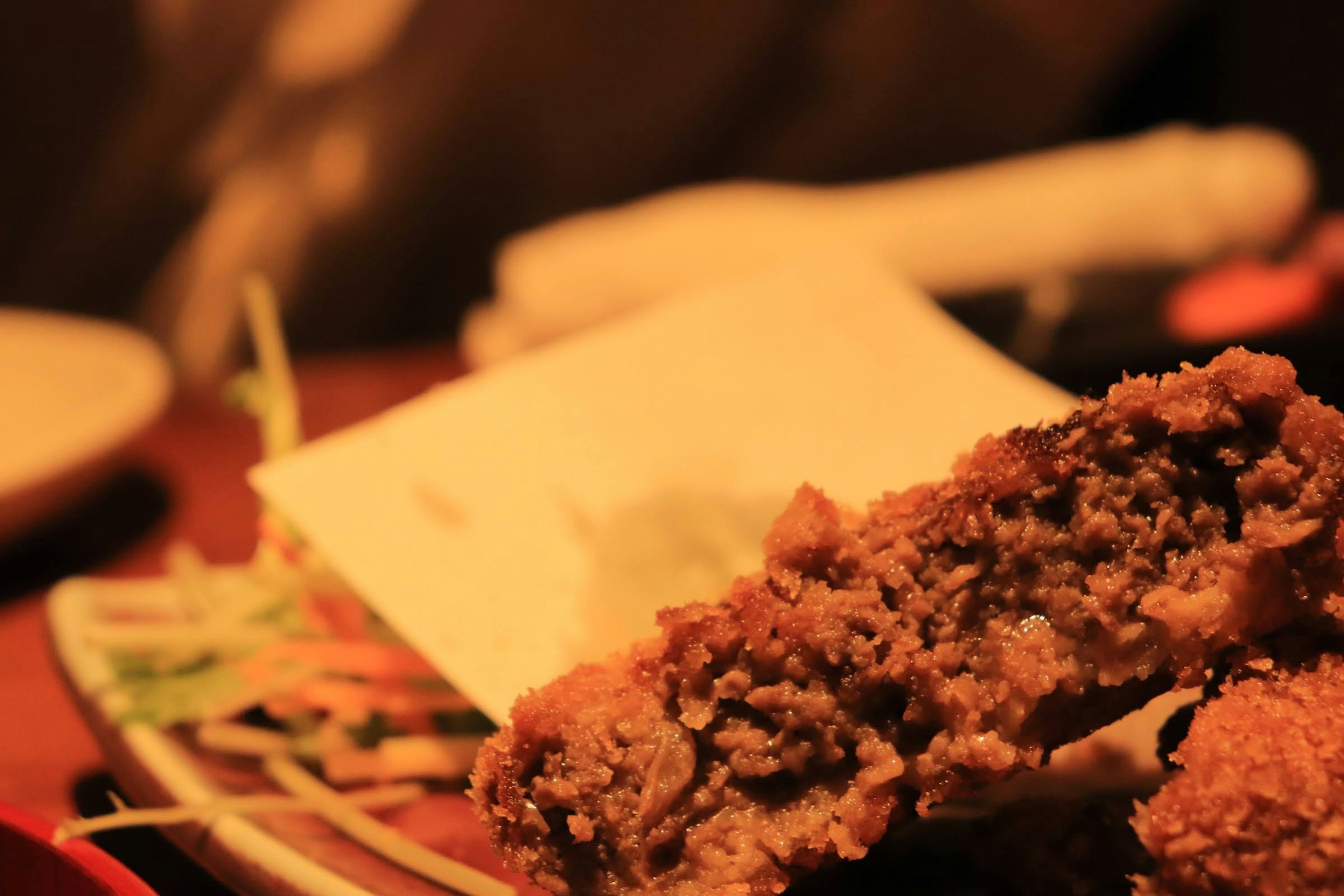 Close-up of a delicious fried food dish showcasing a cut piece