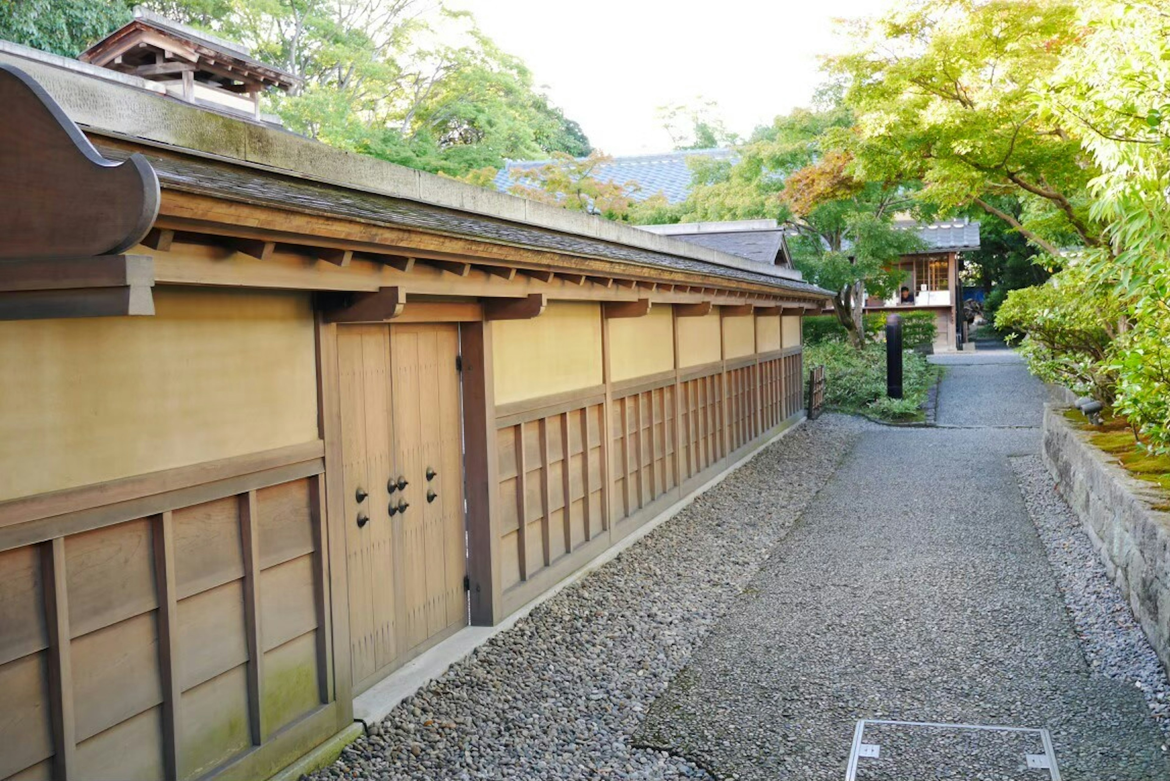 Traditional Japanese wooden building wall with garden path