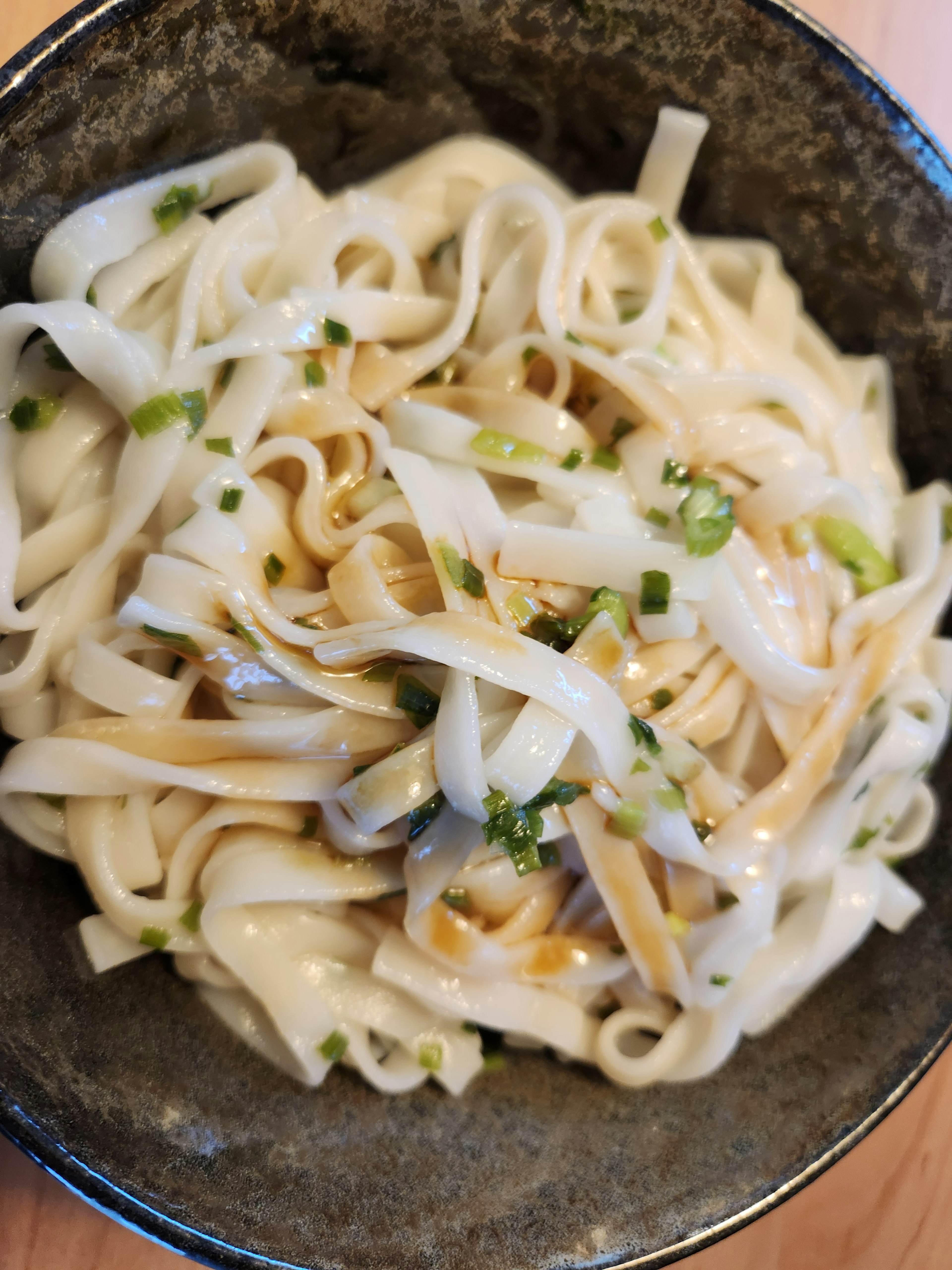 Creamy noodle dish topped with green onions