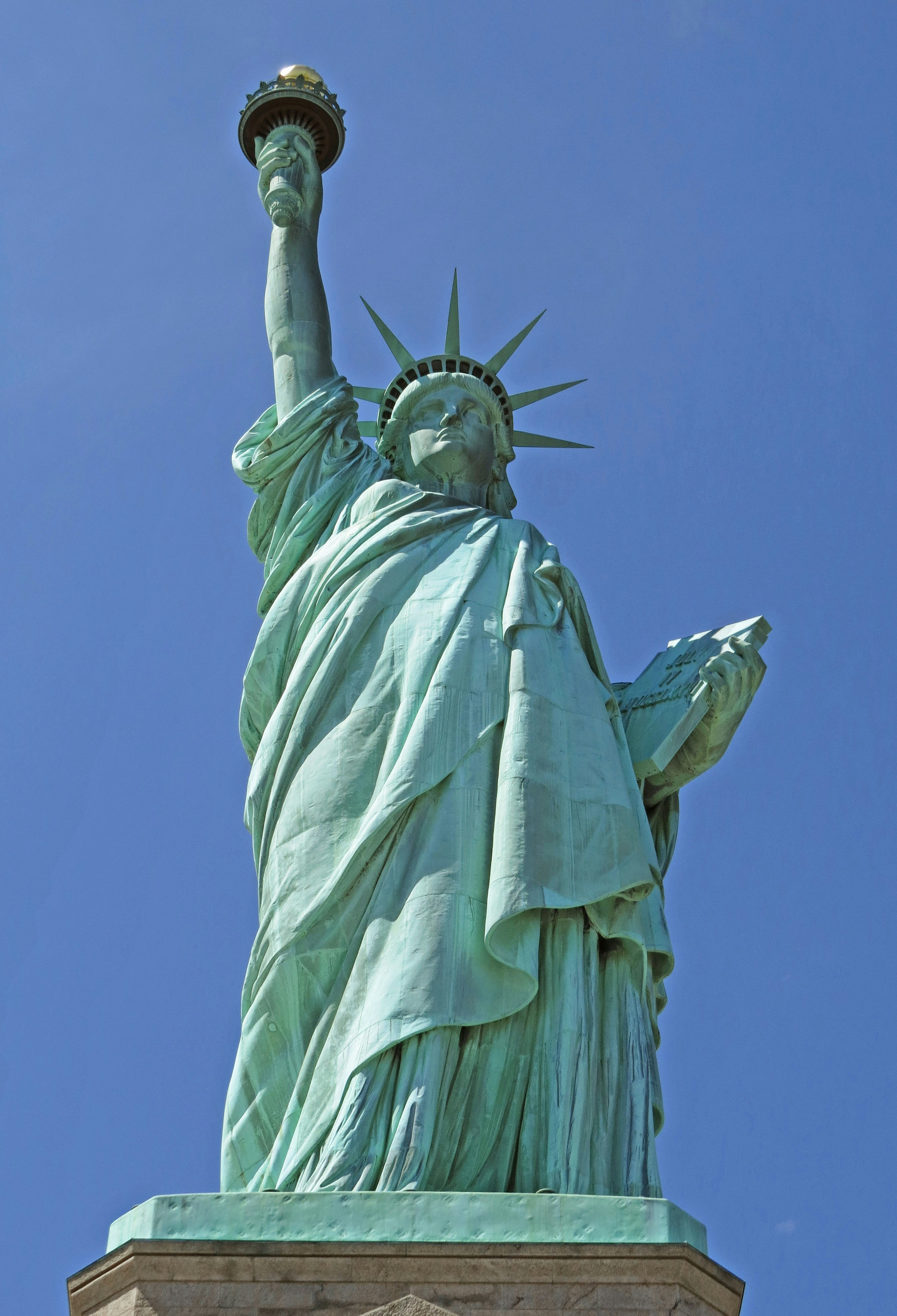 Statue of Liberty holding a torch under a clear blue sky