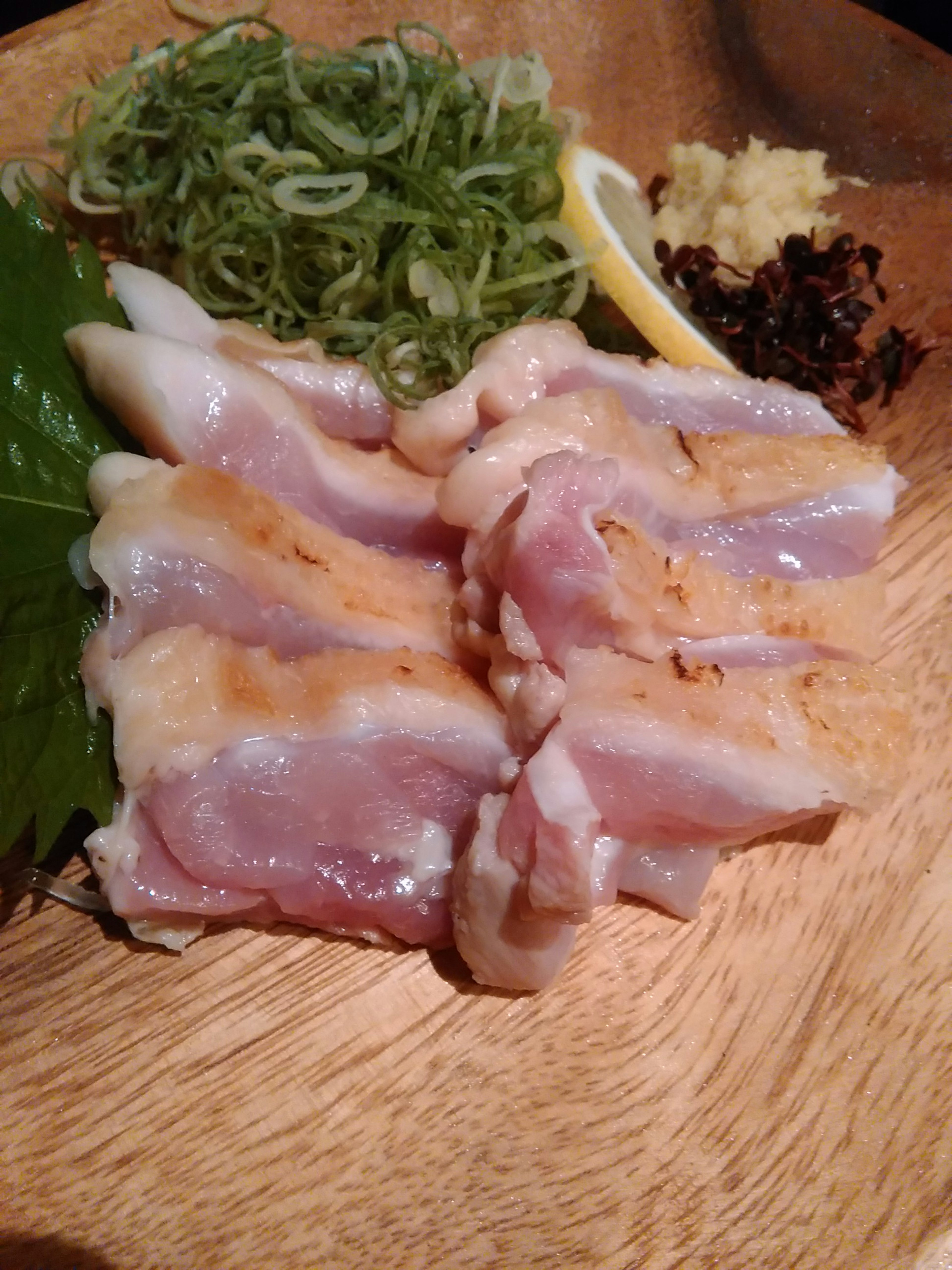 Fresh chicken sashimi with garnishes