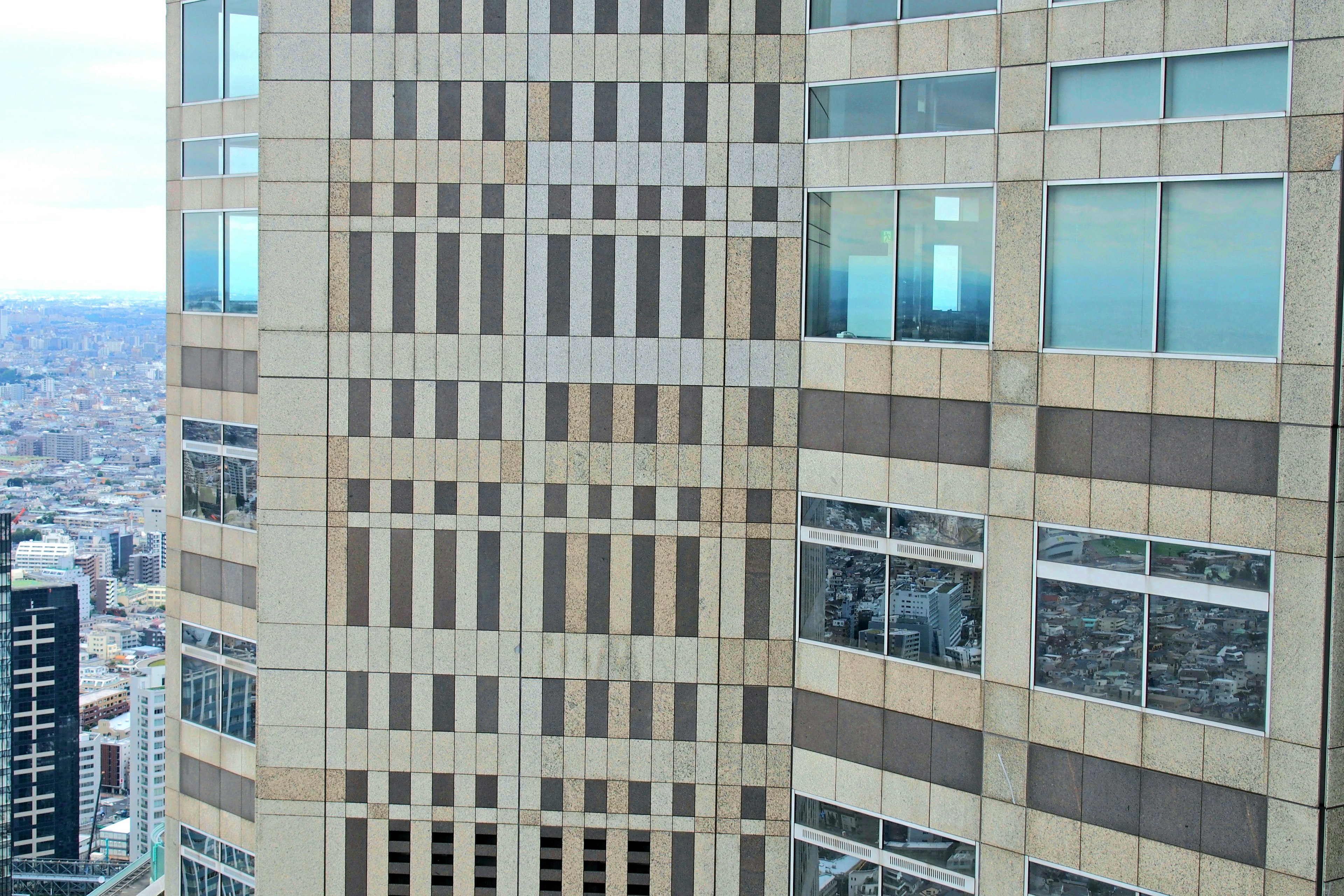 Exterior of a skyscraper featuring prominent horizontal lines and large windows