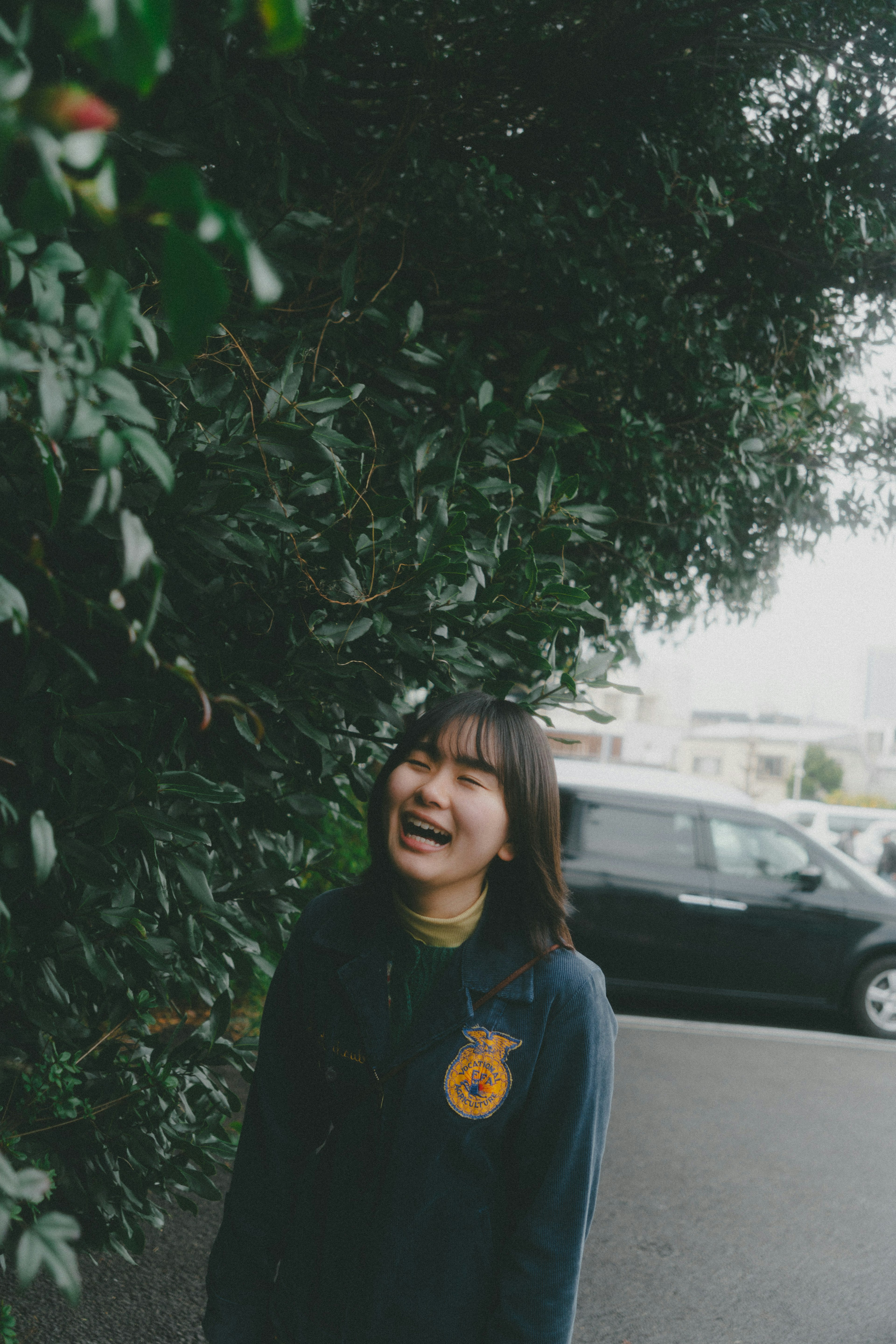 Woman smiling amidst lush green leaves