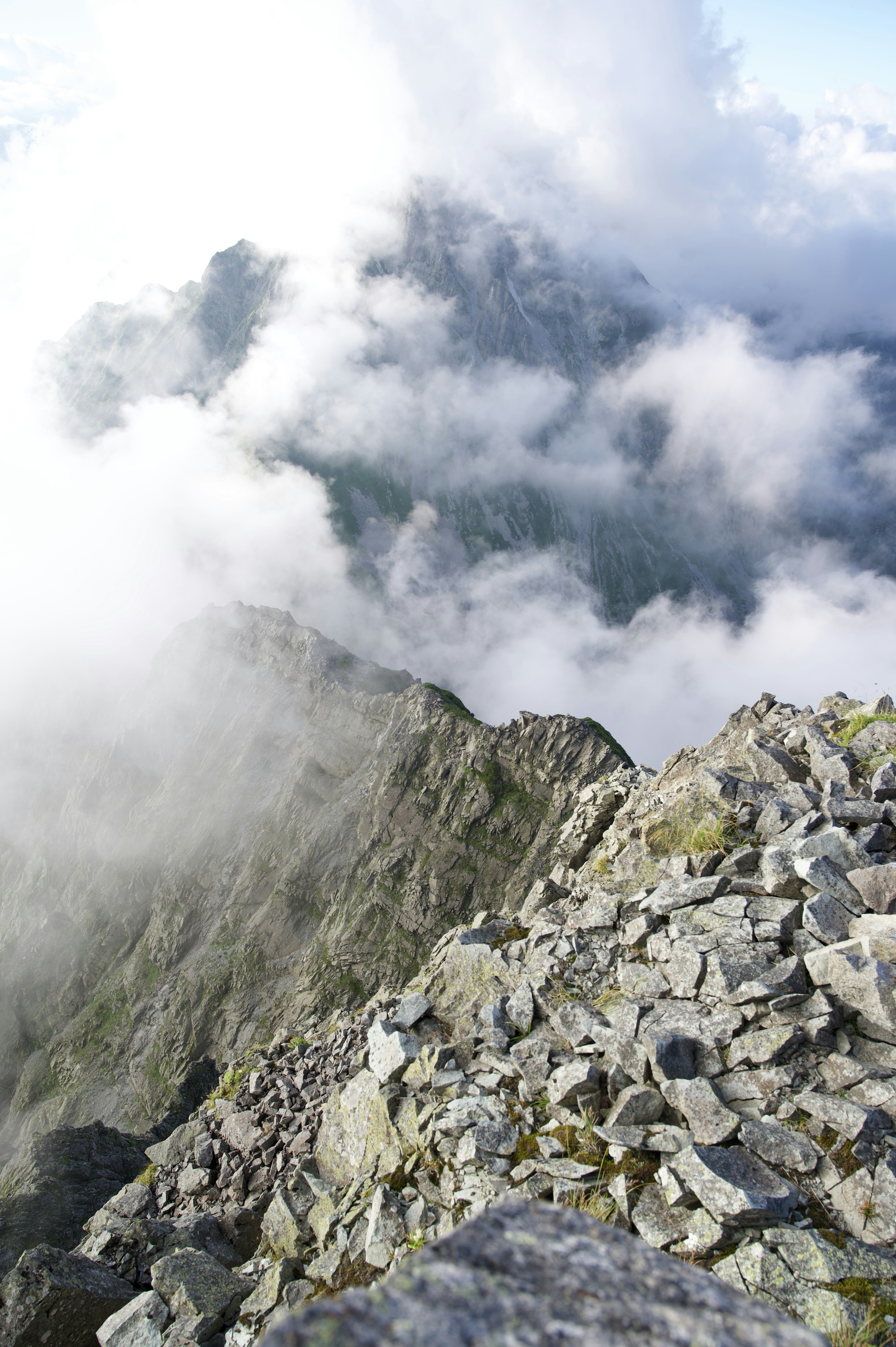 Mountain landscape covered with clouds and rocky terrain