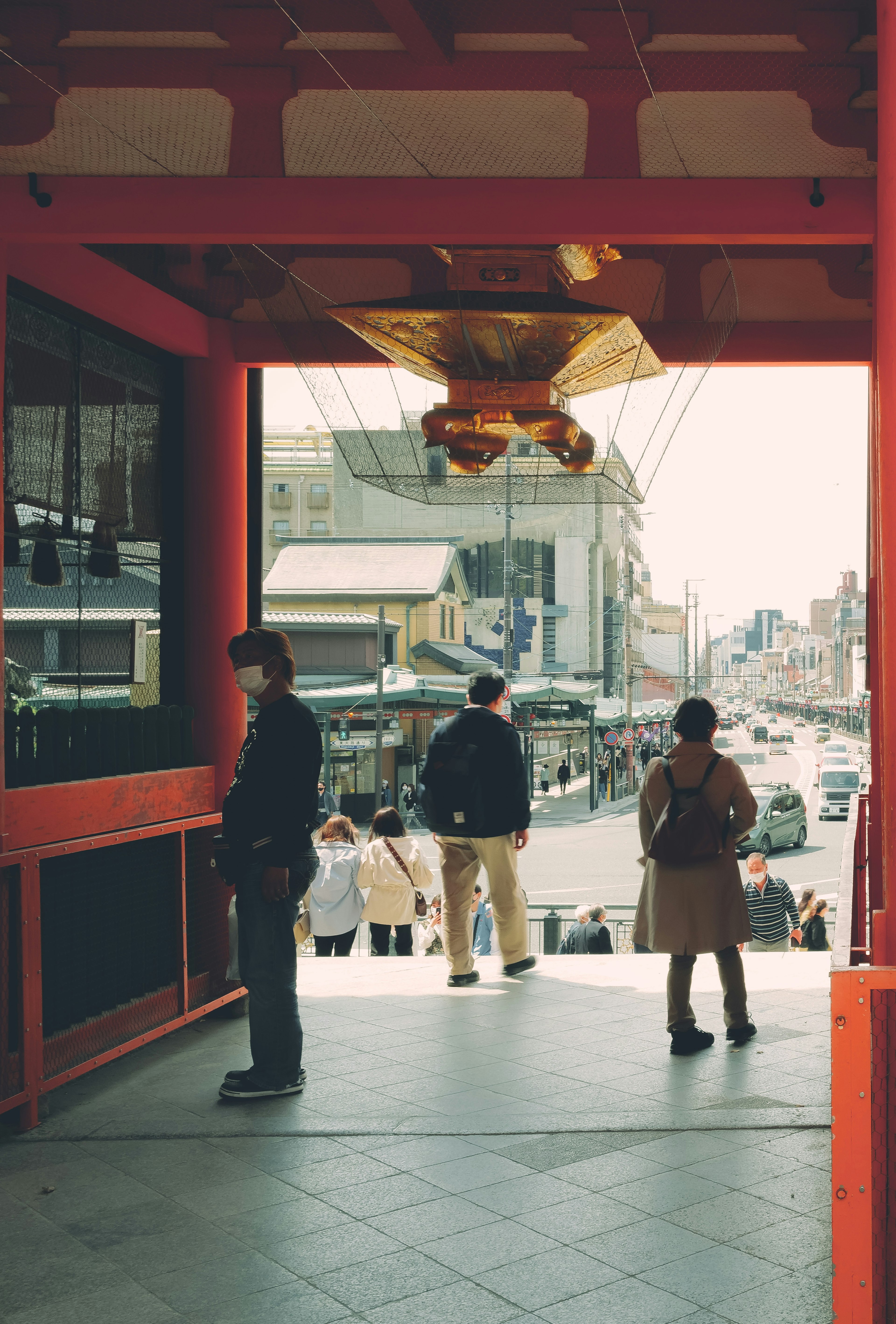 Silhouettes of people looking out from the entrance of a red building