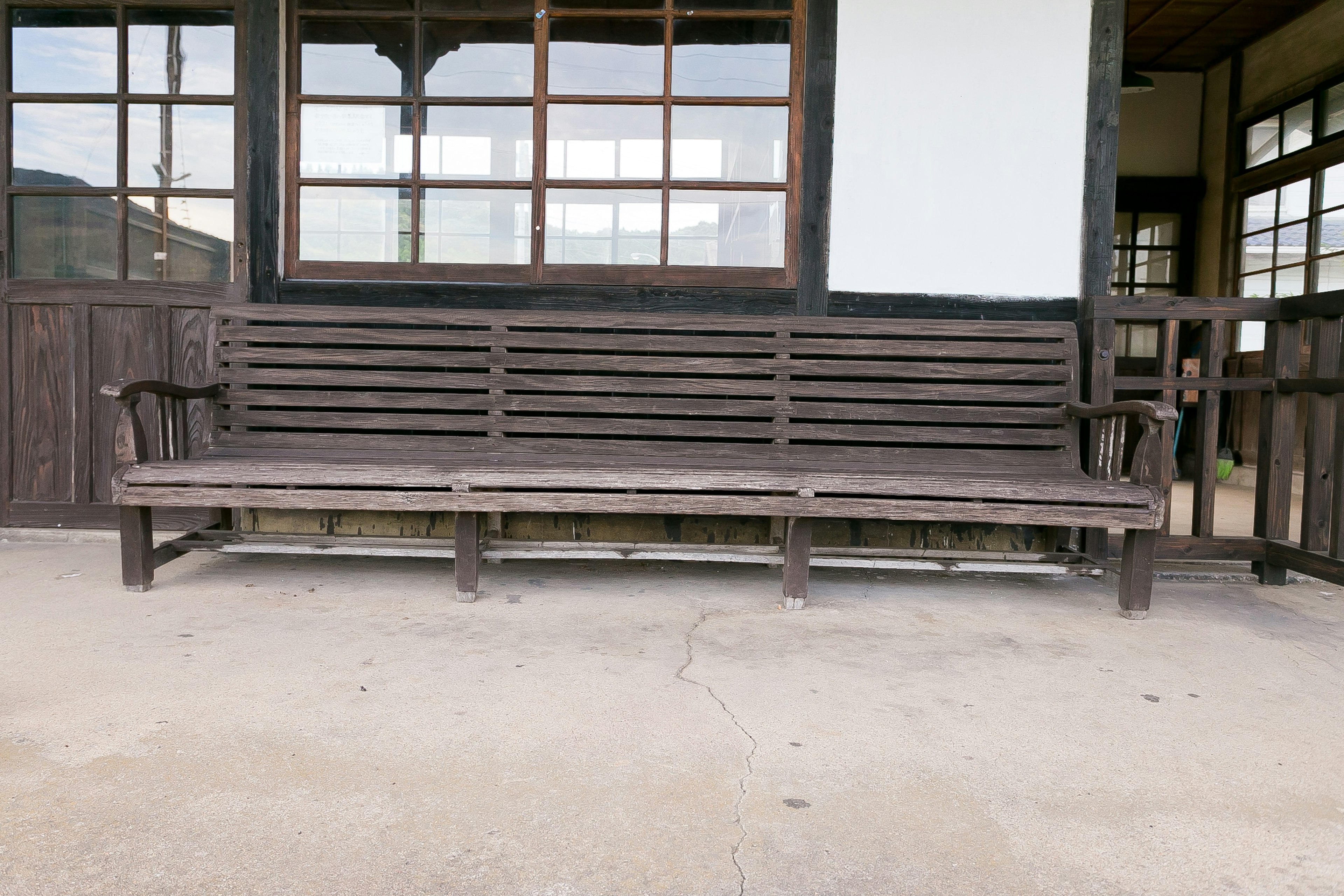 Old building exterior featuring a wooden bench