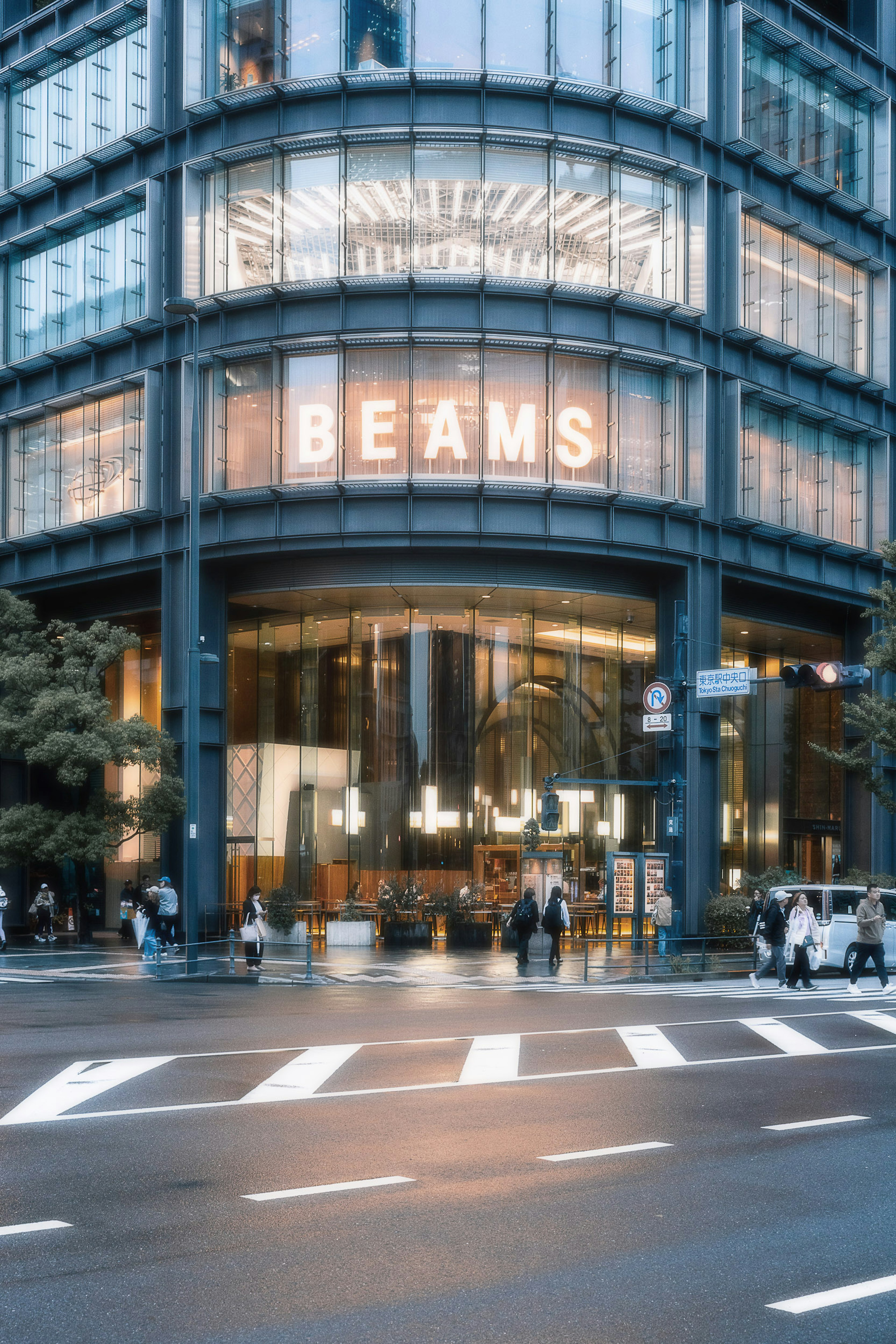 Modern building exterior featuring BEAMS sign with city street view