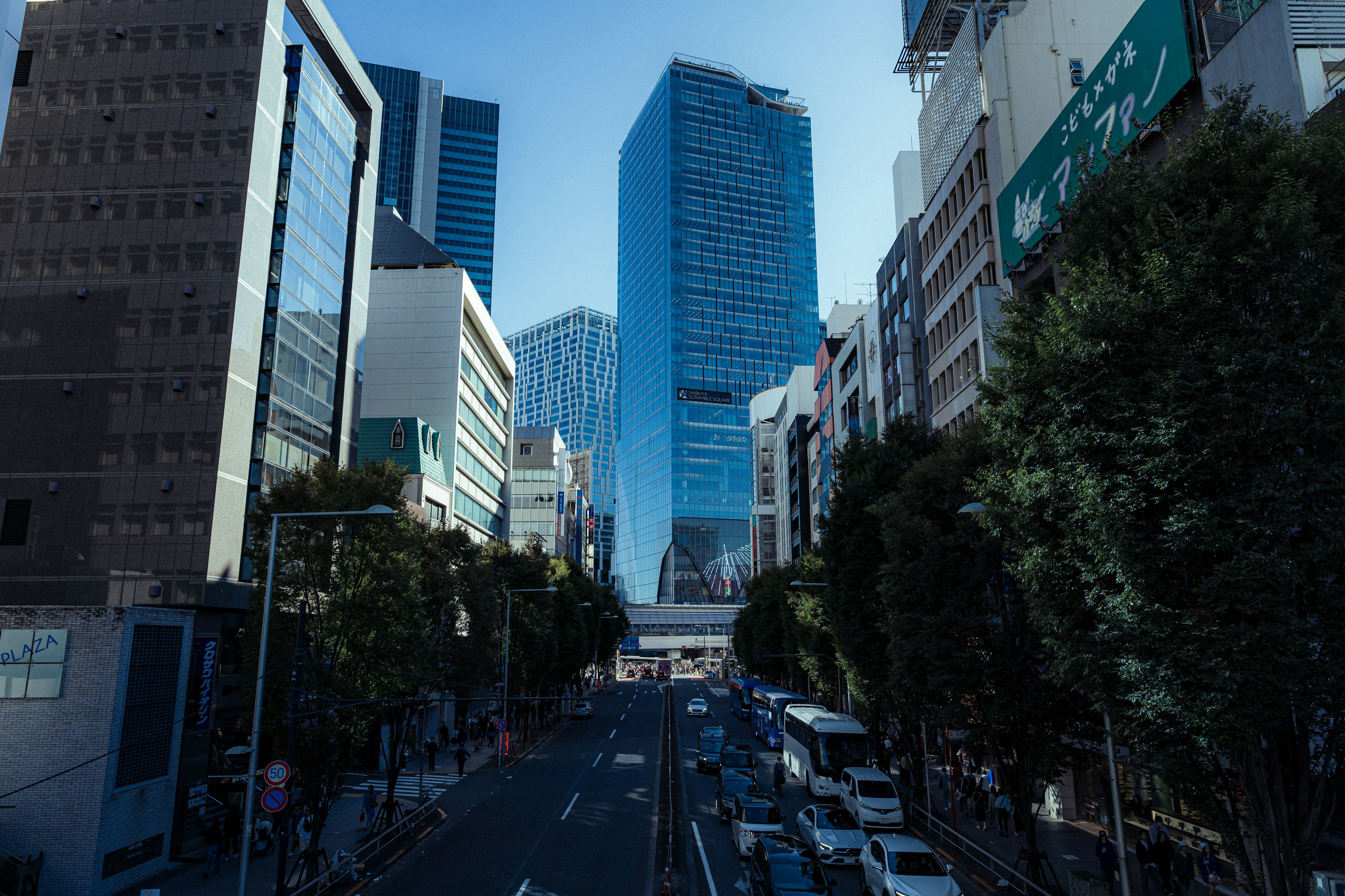 City street featuring tall skyscrapers and busy traffic