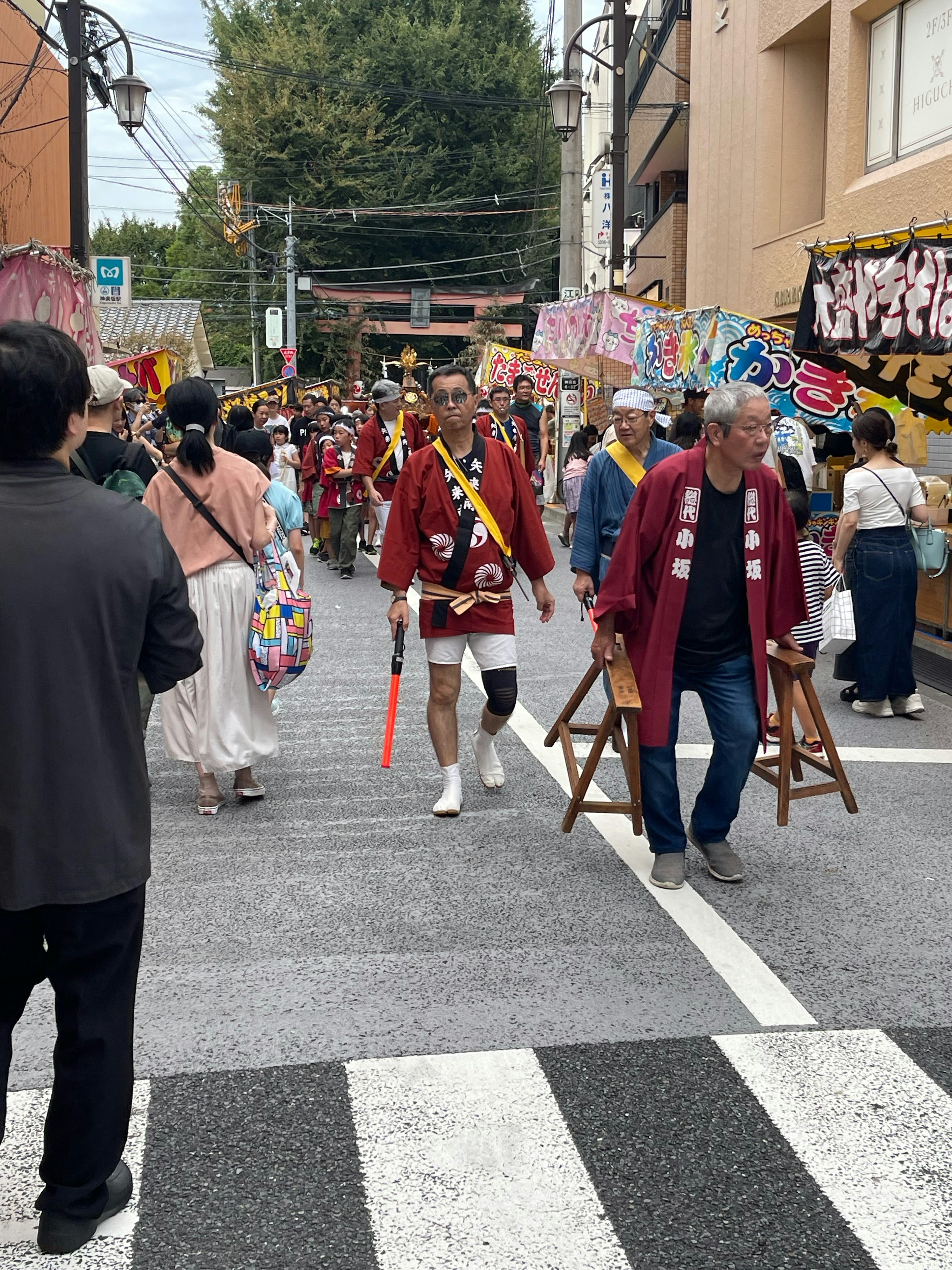 Lively scene of people in festival attire walking down the street