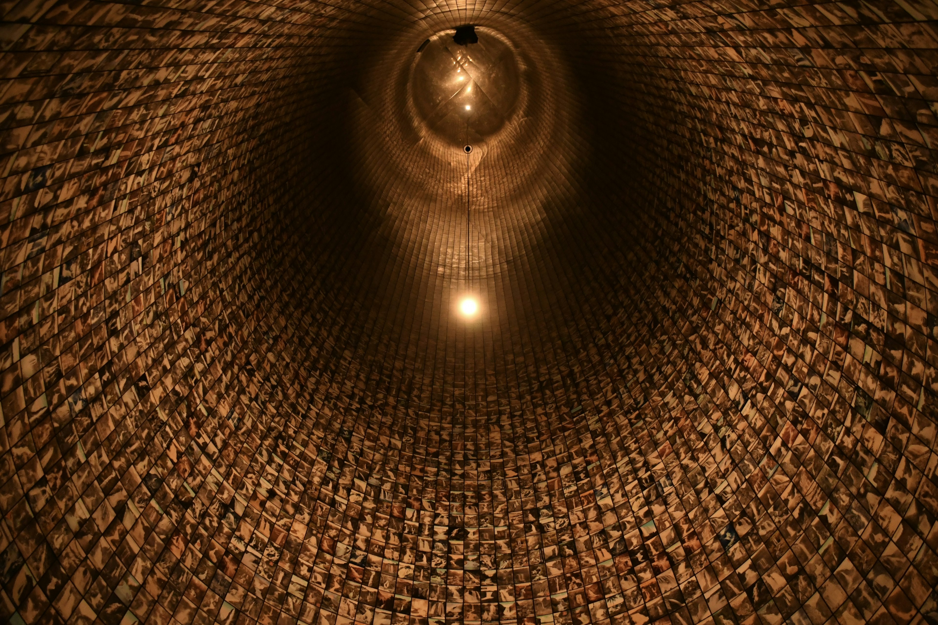 View looking up inside a cylindrical structure made of bricks