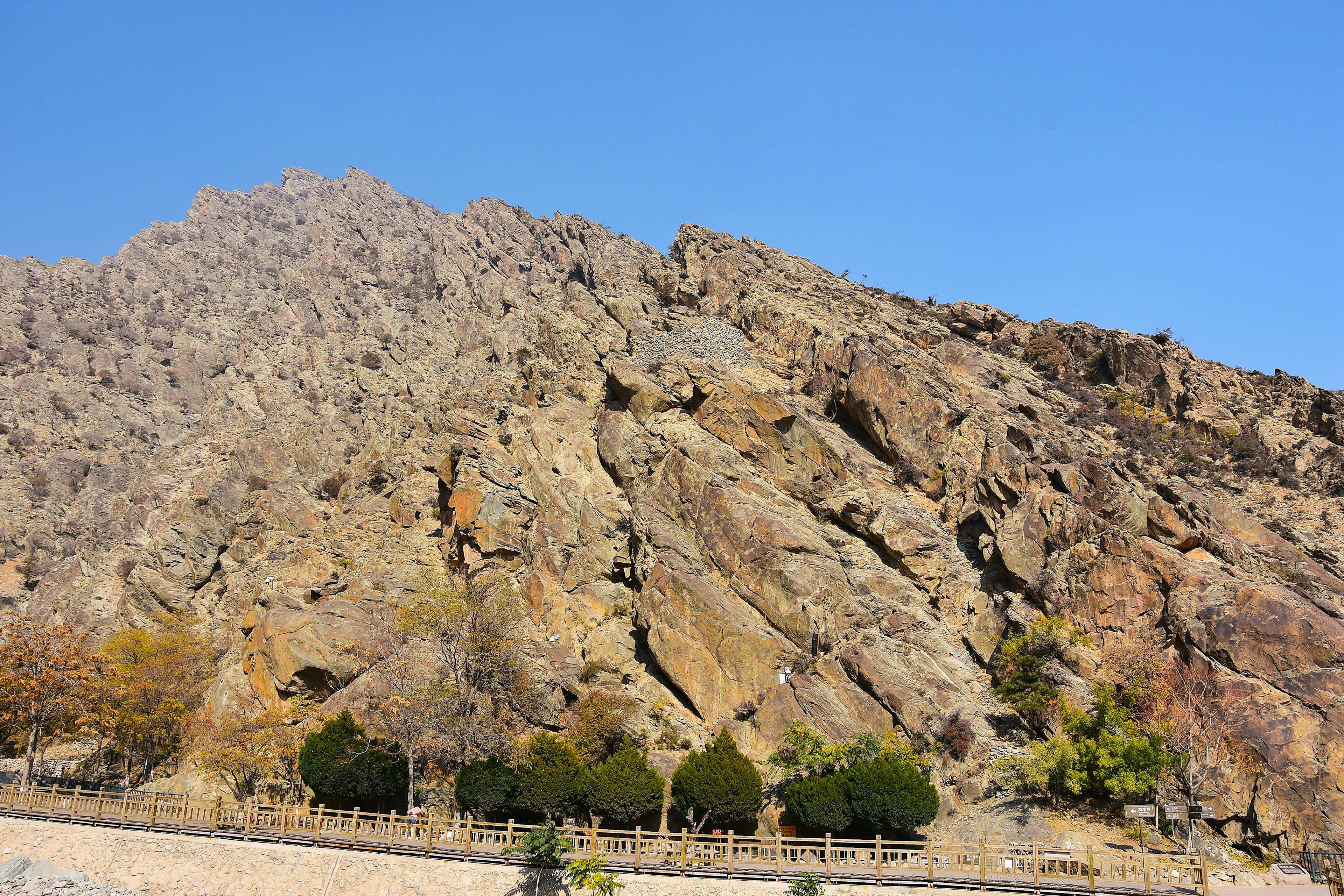 Rocky mountain landscape with clear blue sky and green trees