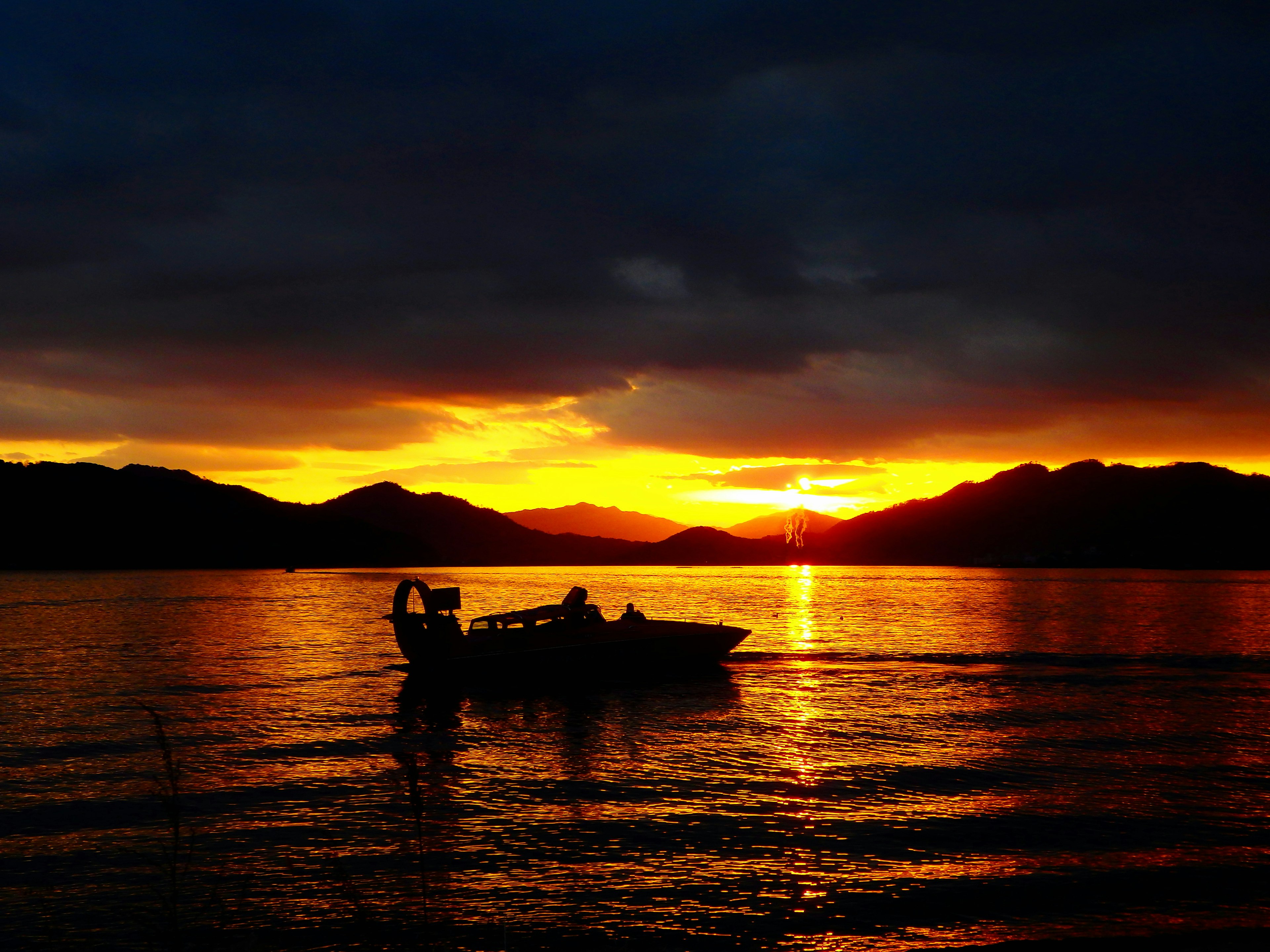 Silhouette of a boat on a lake at sunset