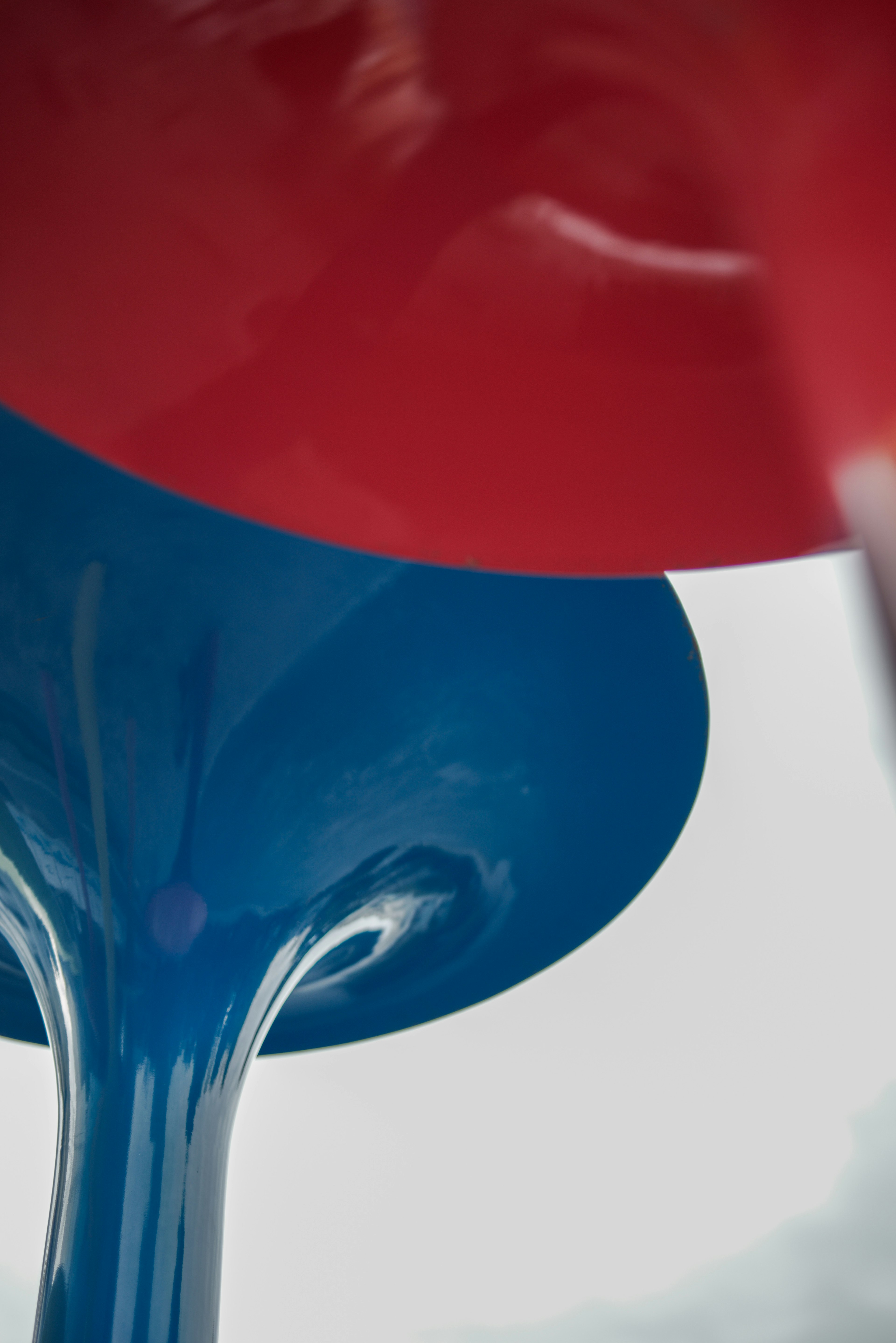 Colorful chair with red and blue parts viewed from below