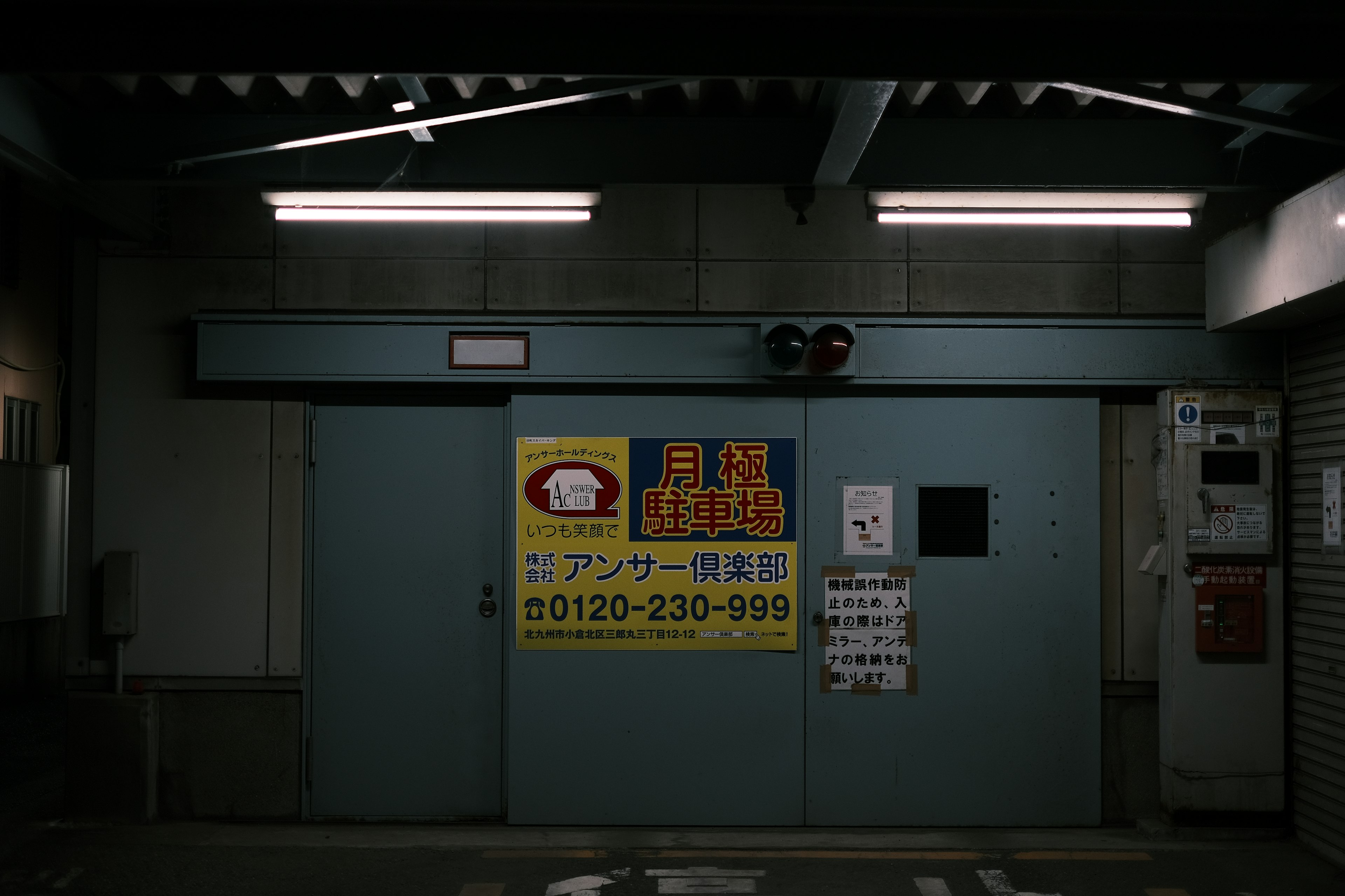 Blue door with a yellow sign displaying contact information and white text