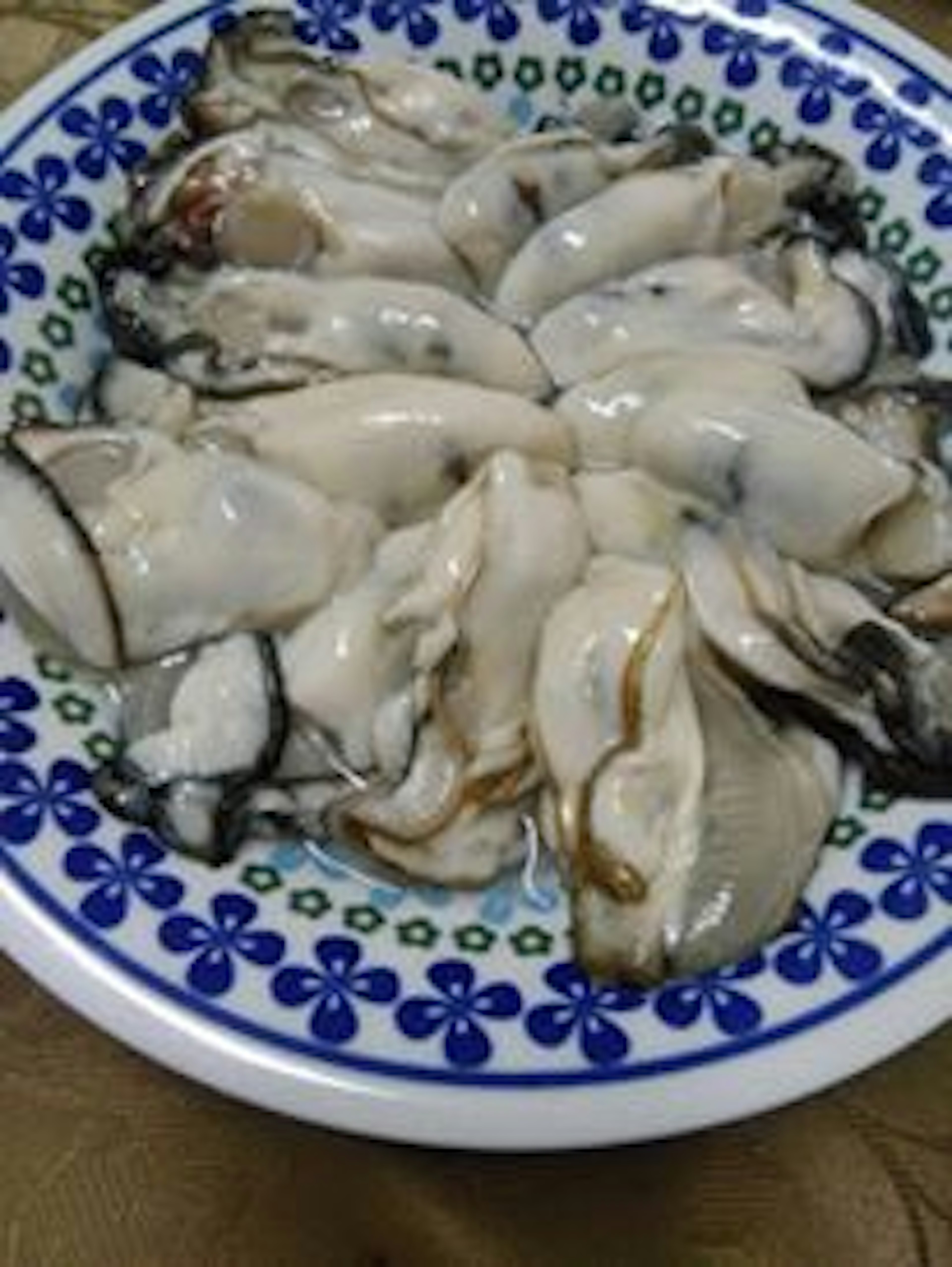 A plate of fresh raw oysters arranged neatly