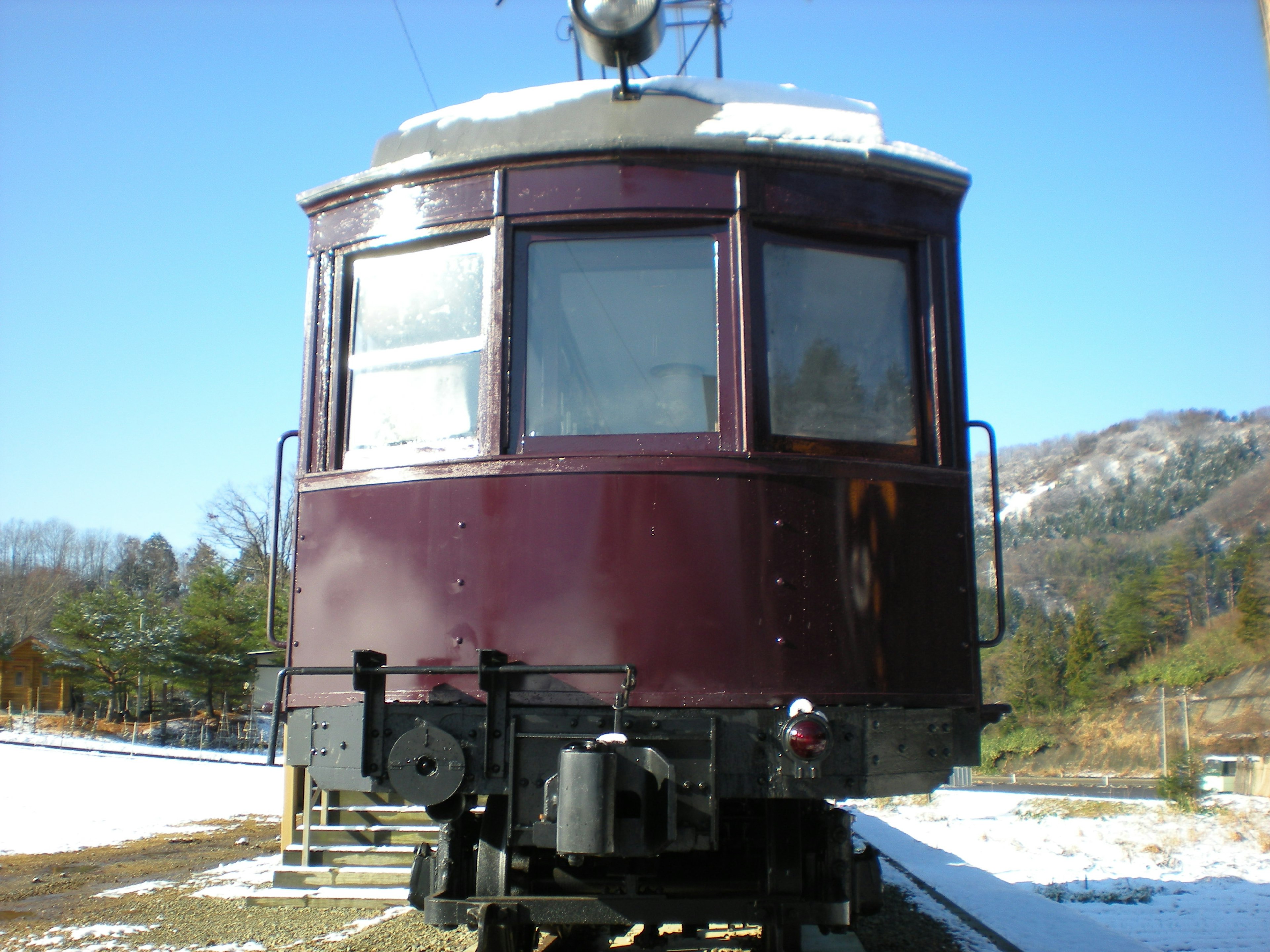 Old purple train cabin in a snowy landscape