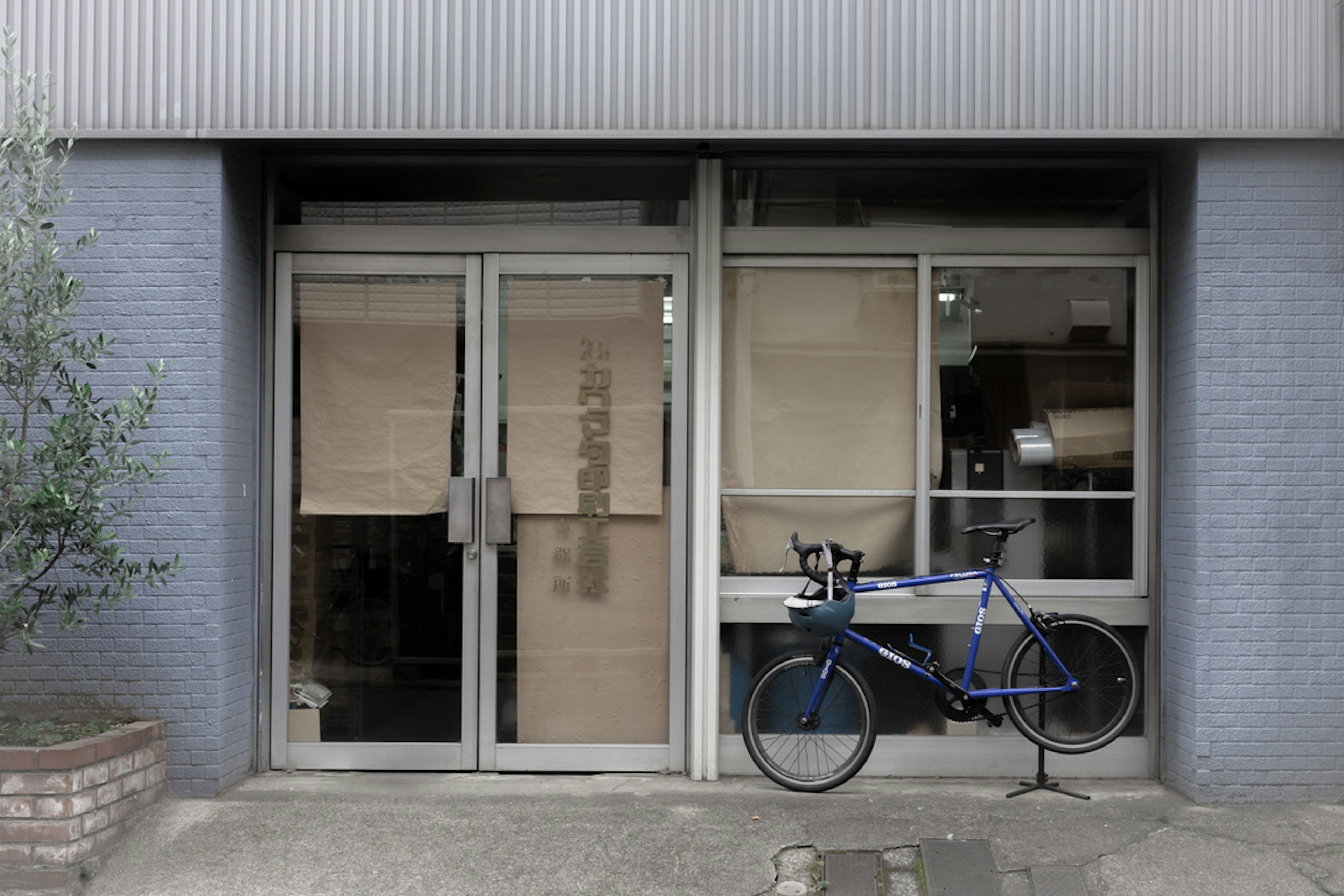 Photo of a commercial building entrance with a blue bicycle