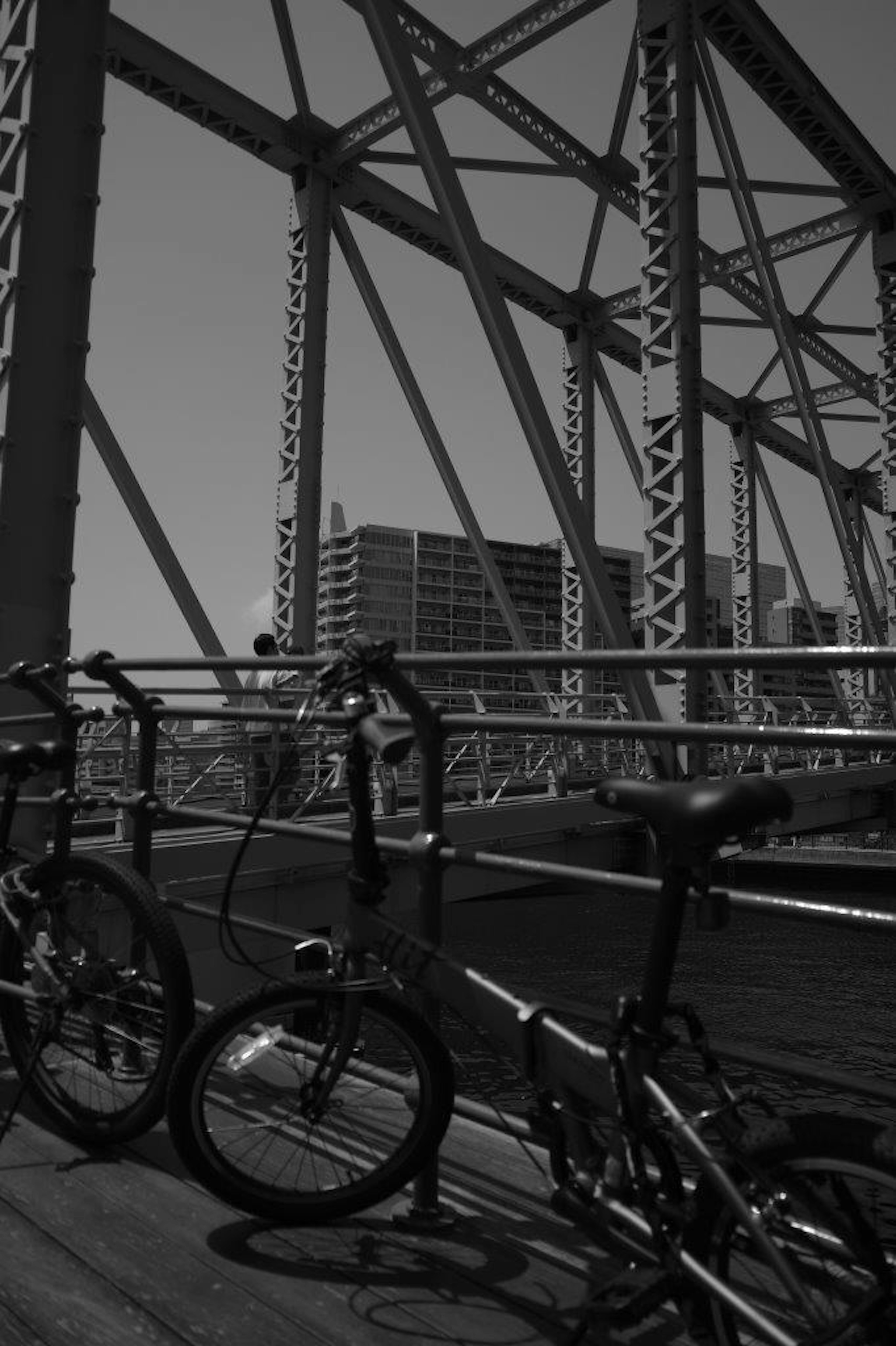 Bicycles parked on a bridge with a cityscape background