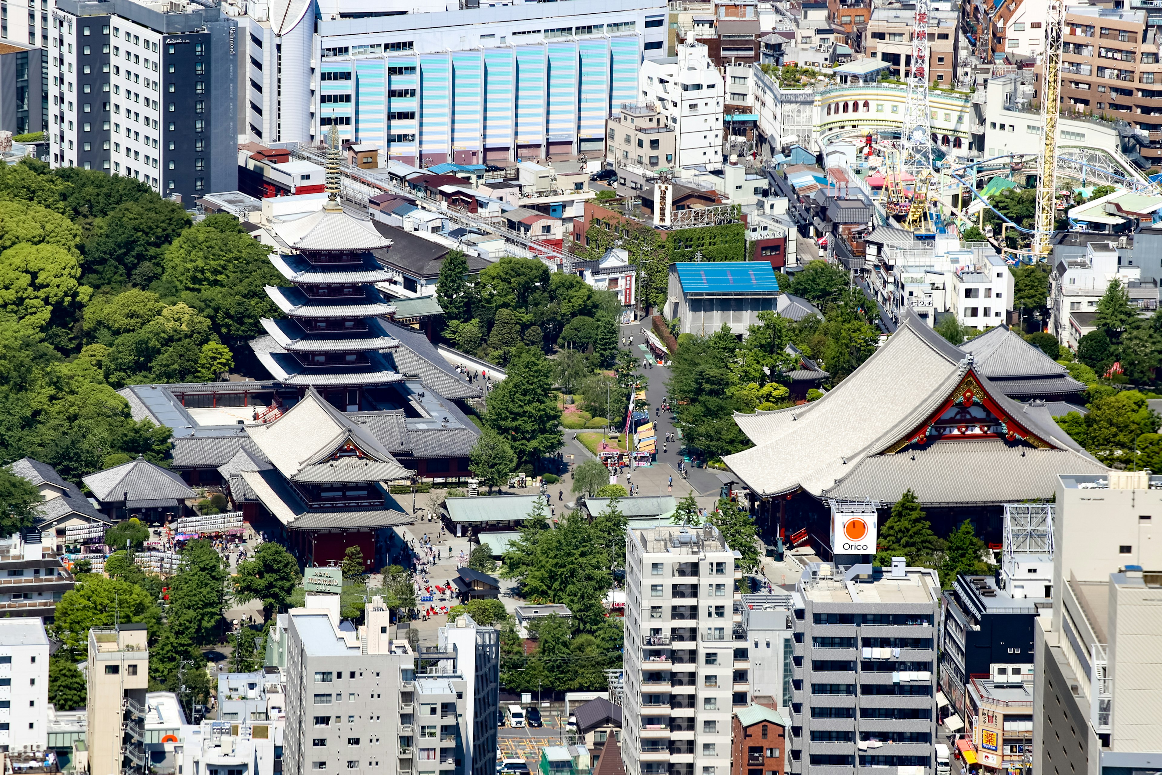 Aerial view of traditional Japanese temples surrounded by modern buildings