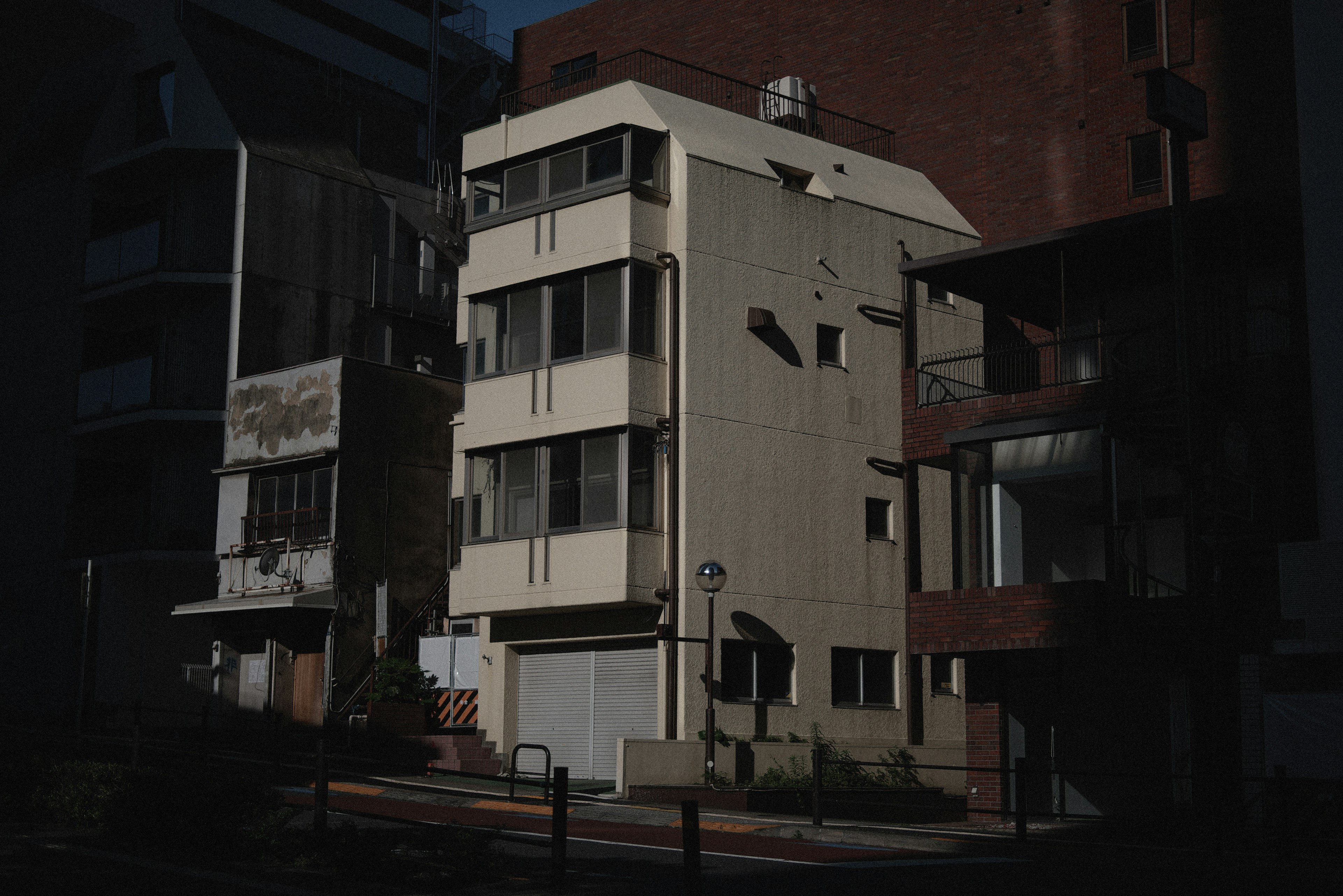 Contemporary building facade in a dimly lit street