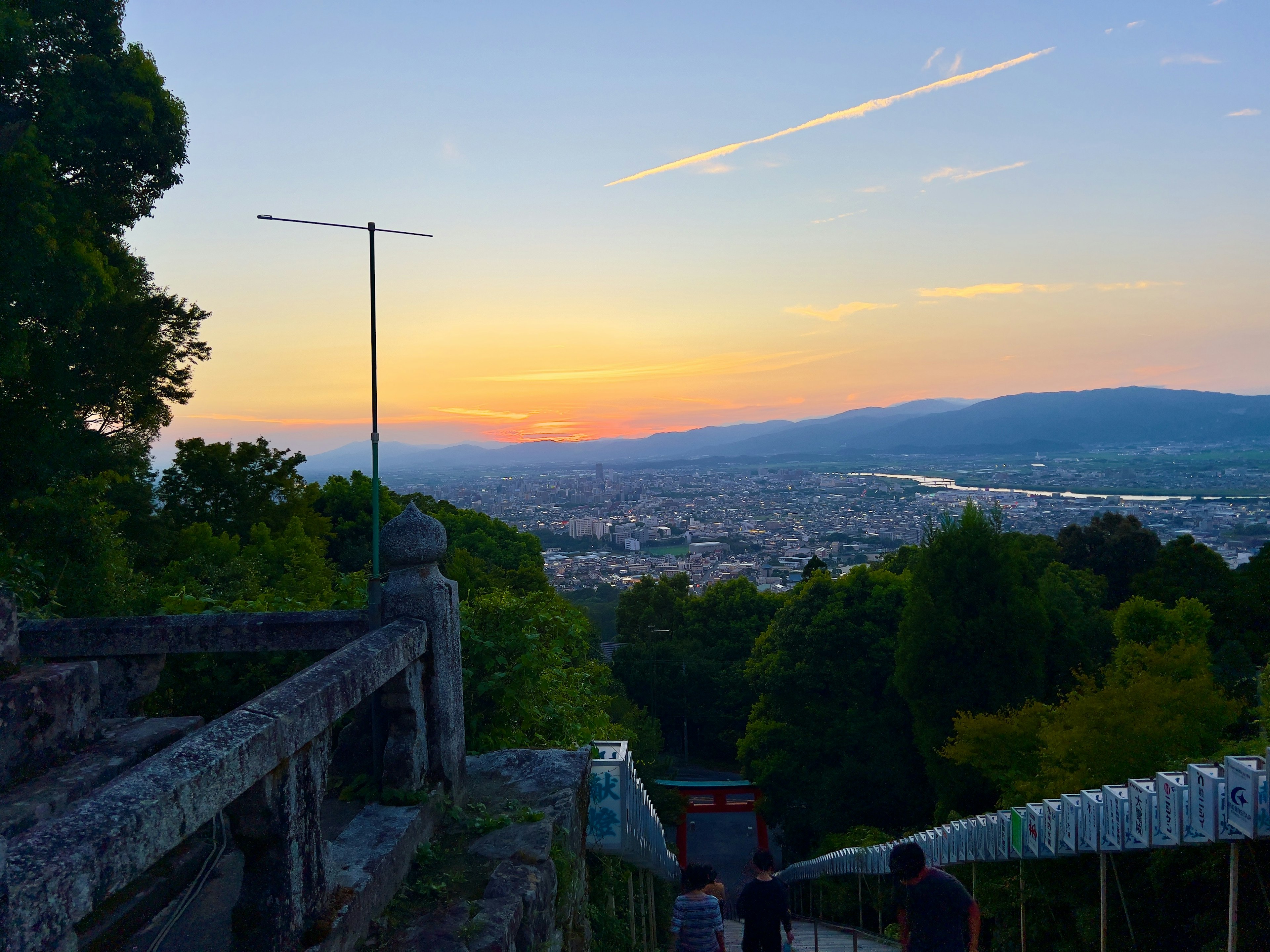 夕日が沈む景色を背景にした街のパノラマビューと階段