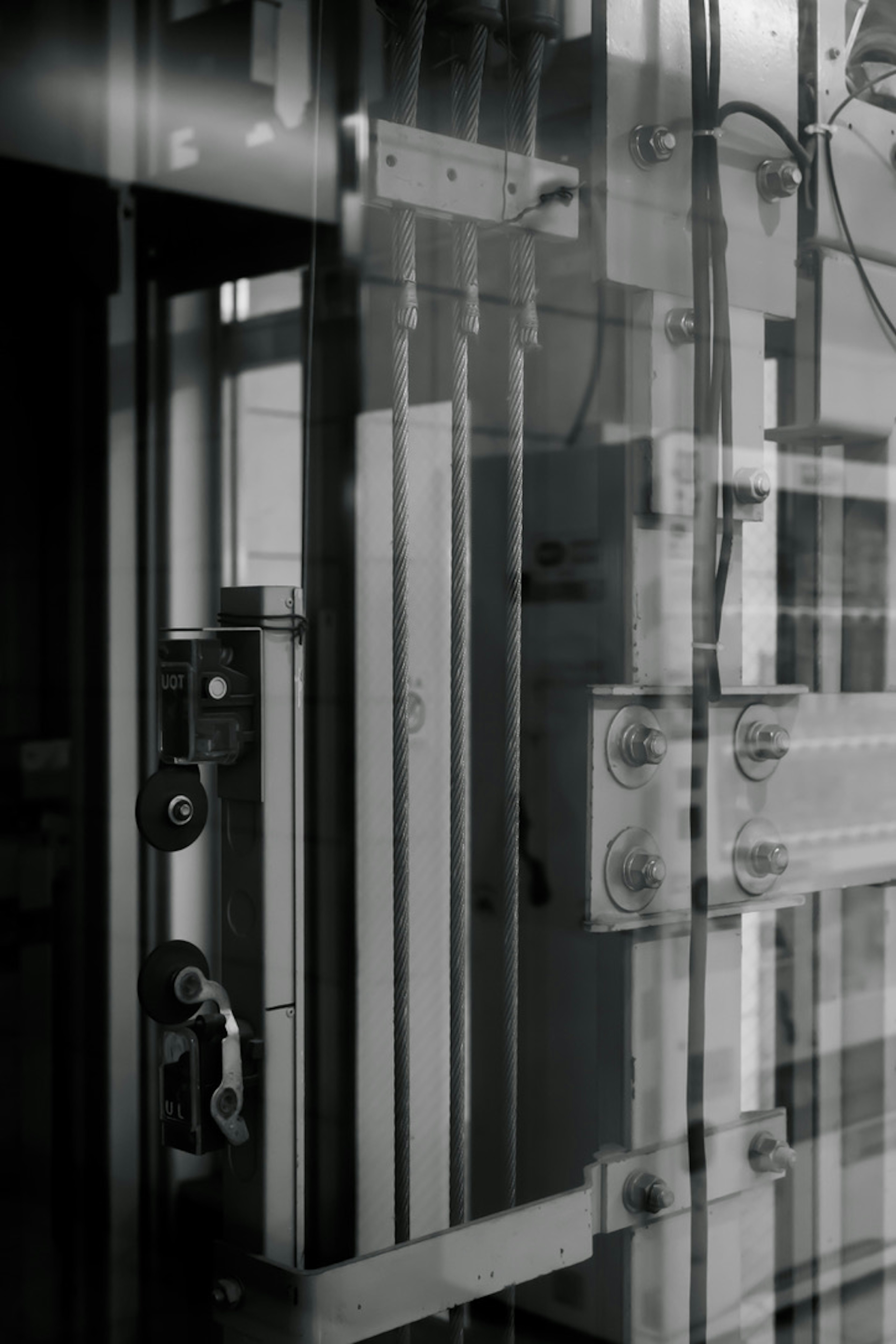 Black and white photo of mechanical interior showing components and cables