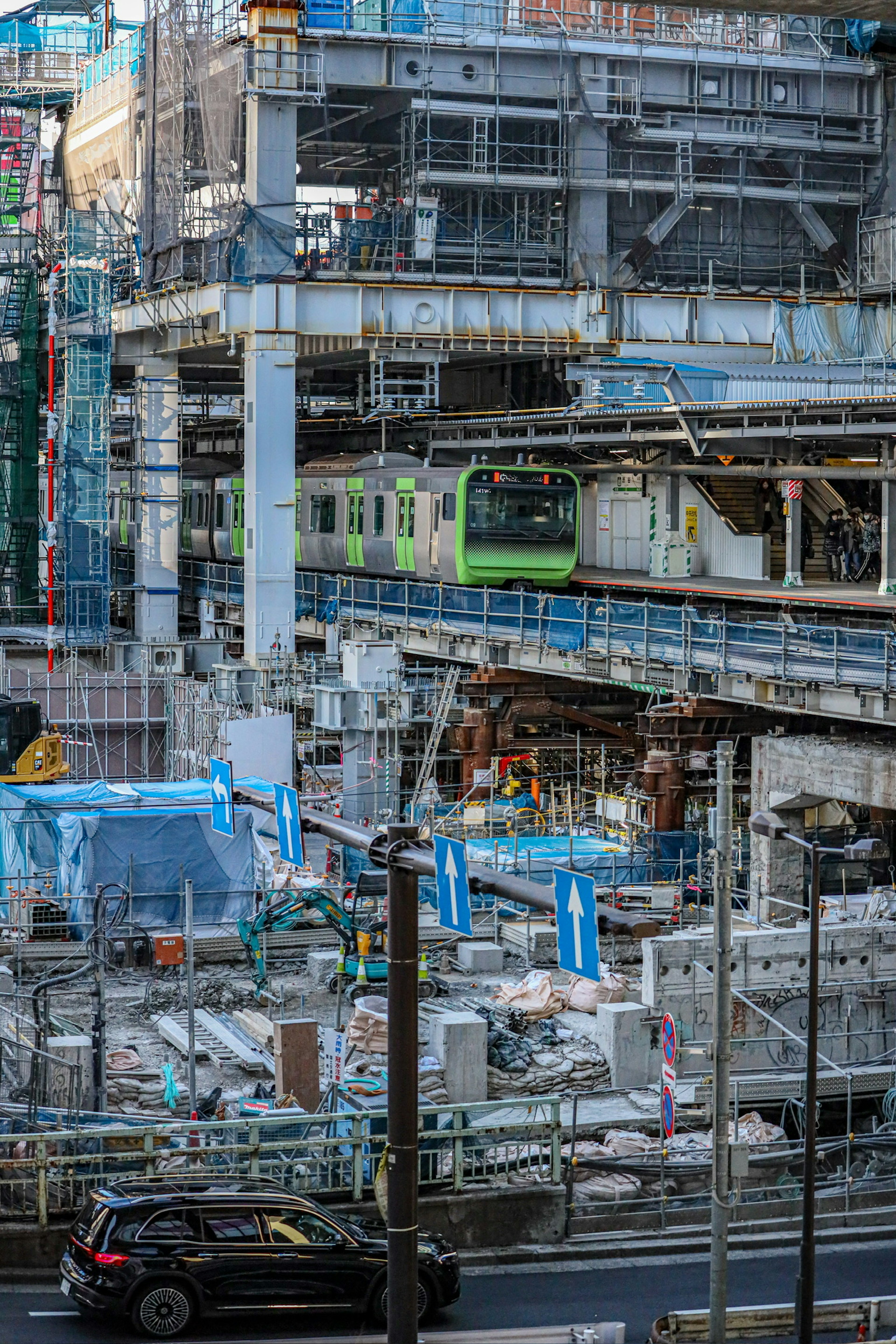 Urban landscape featuring a construction site and a green train