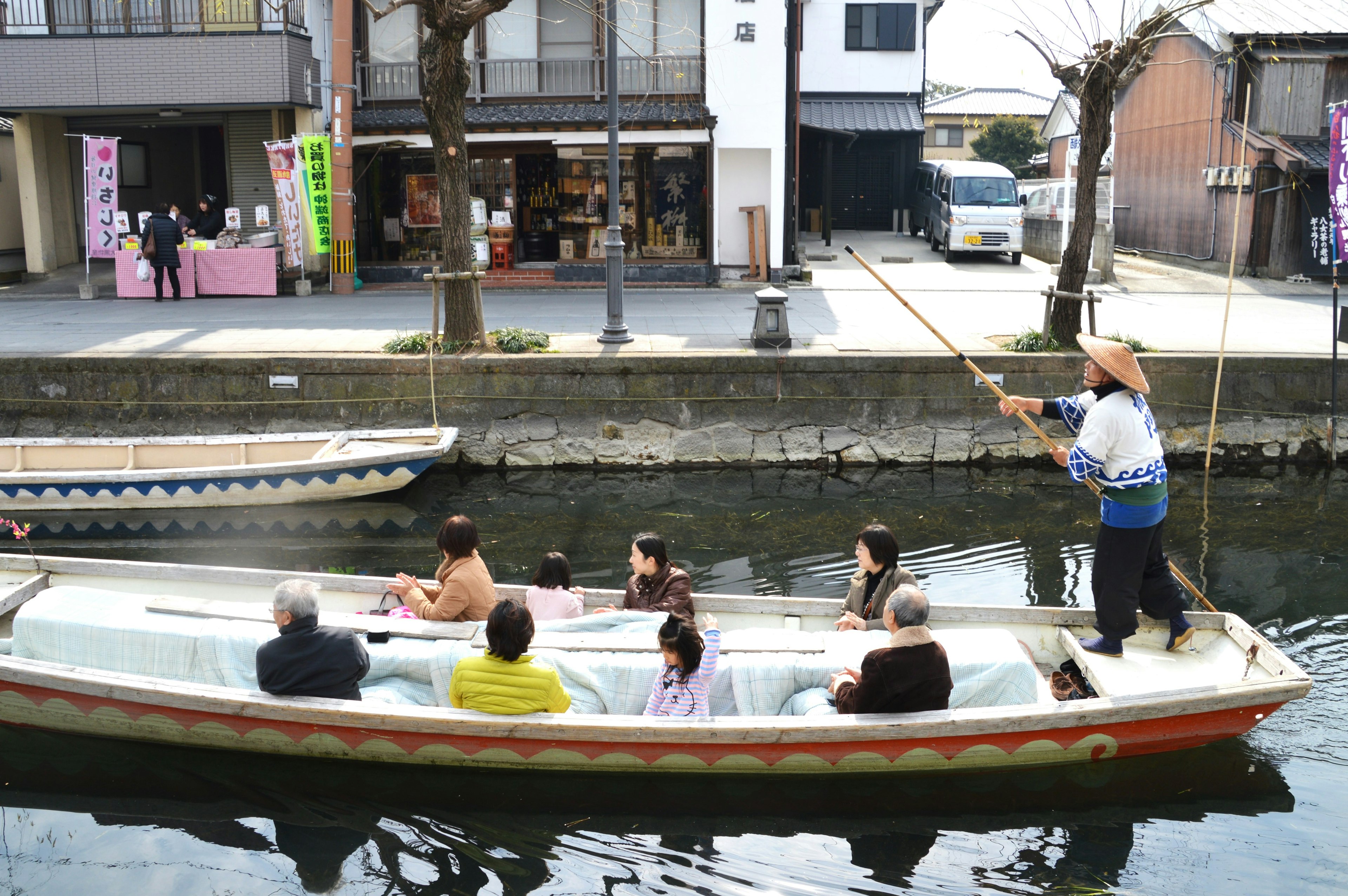 A scenic view of a sightseeing boat with passengers on a canal