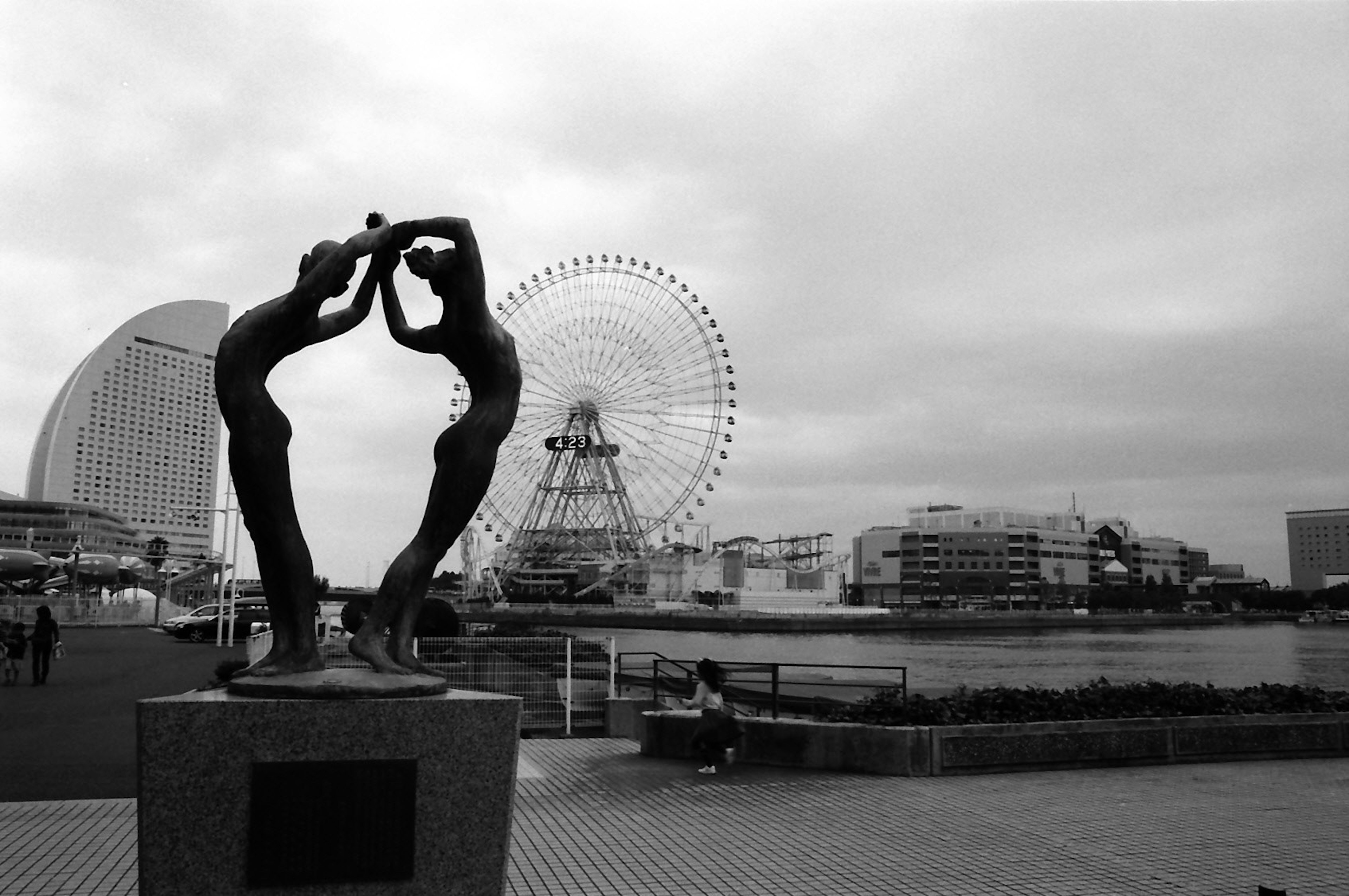 Black and white sculpture with a Ferris wheel in the background