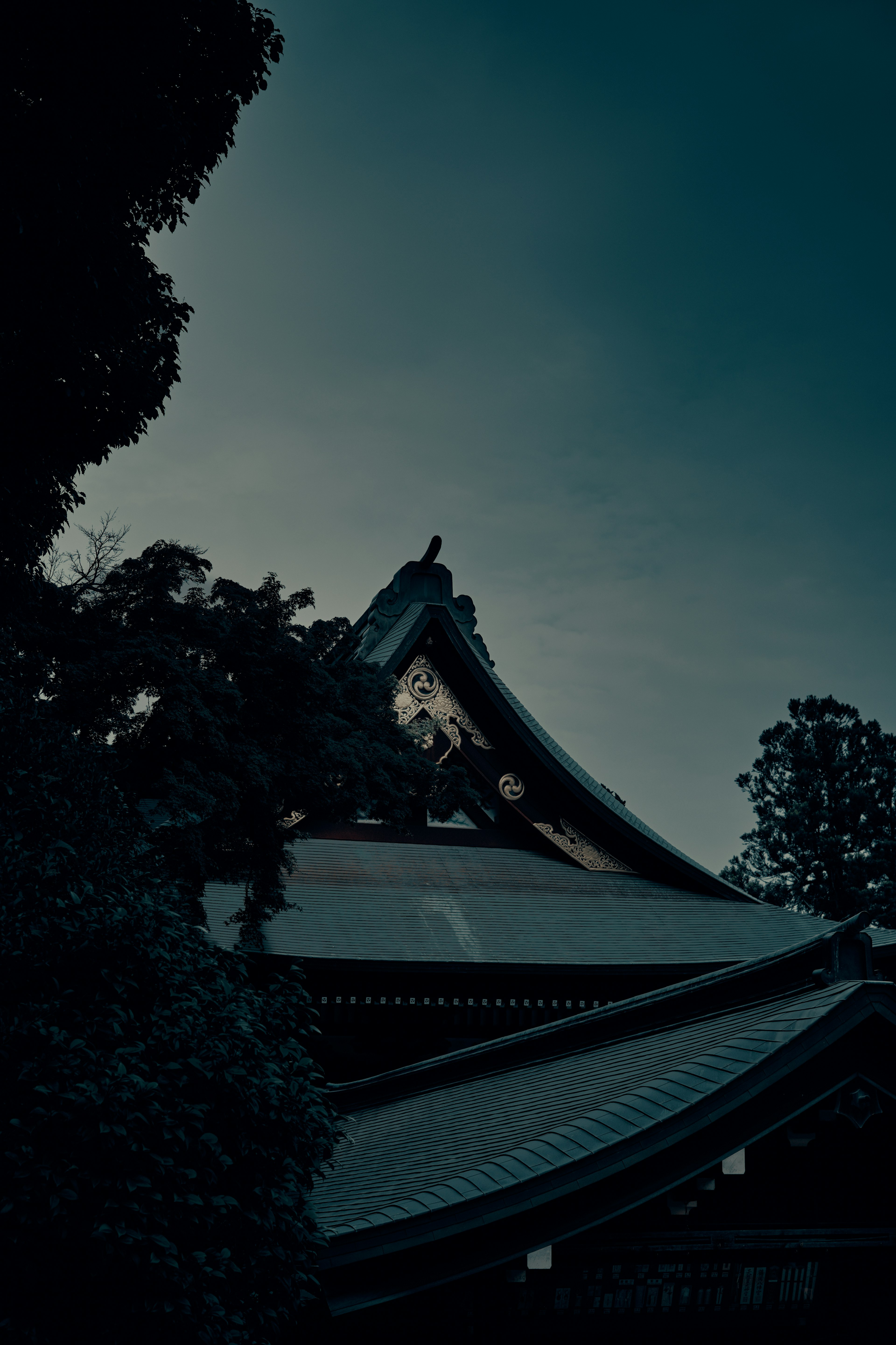 夕暮れ時の神社の屋根のシルエット