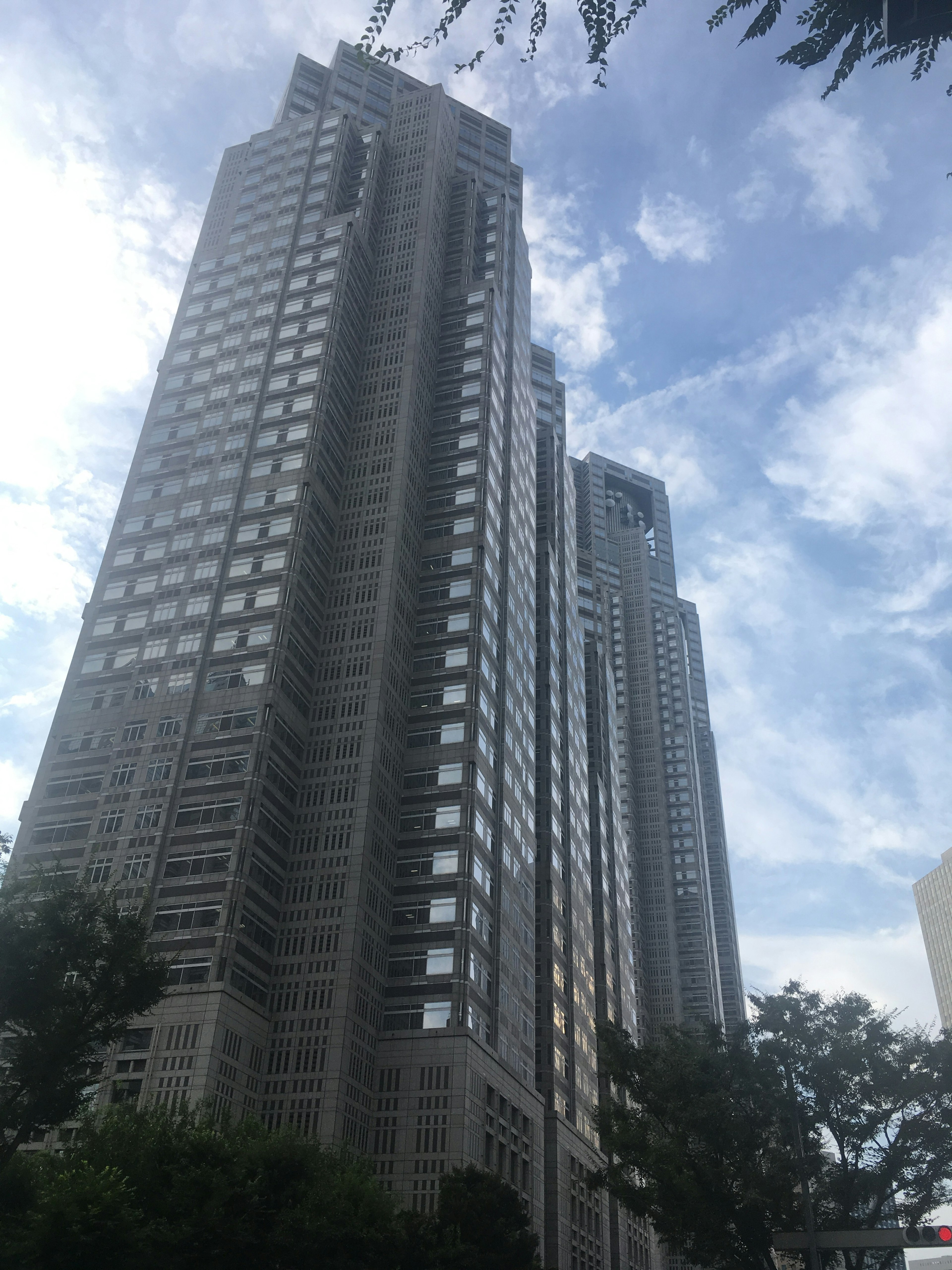 Photo of skyscrapers with a clear blue sky and clouds