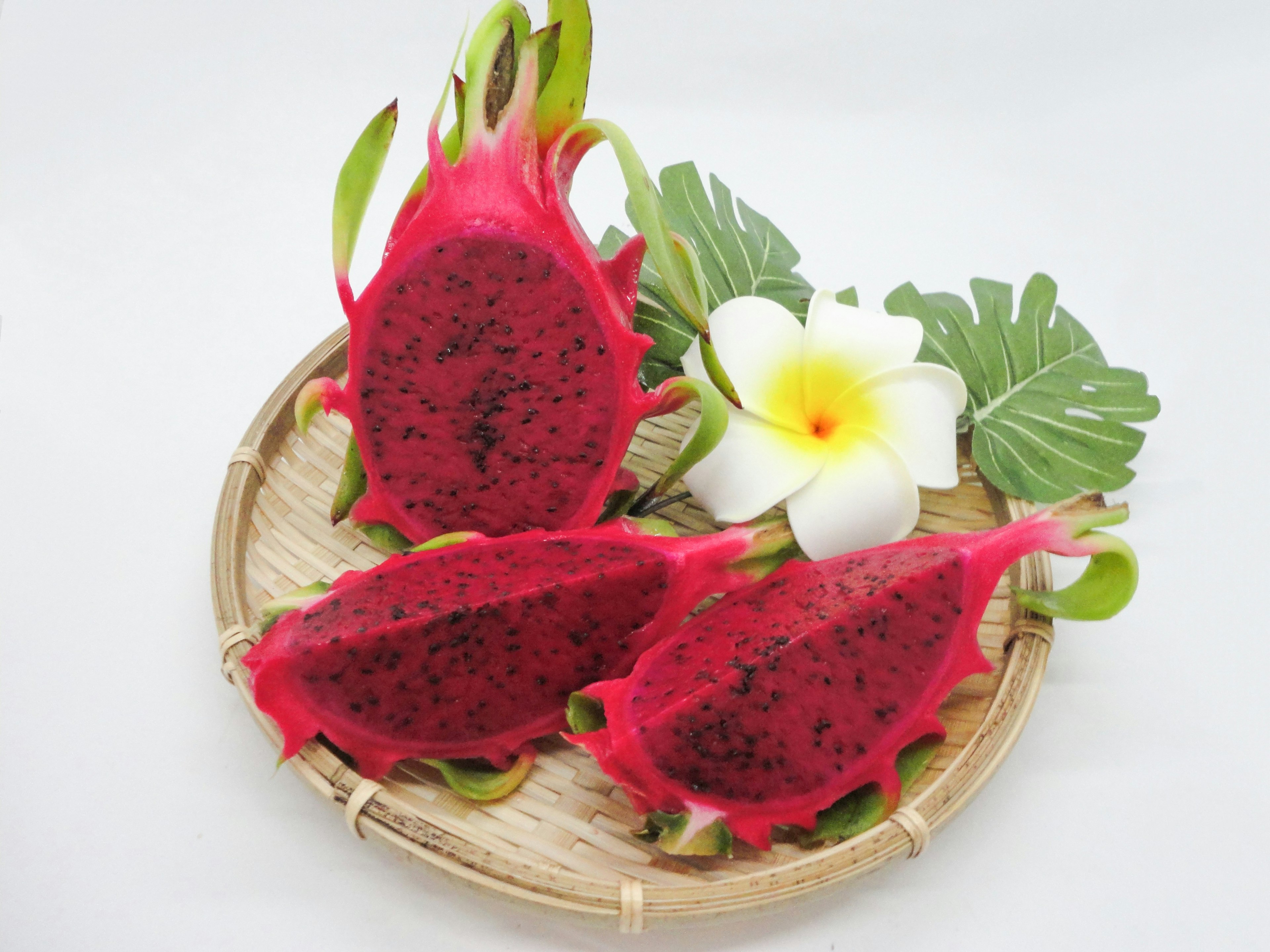 Vibrant dragon fruit slices with a white flower arrangement