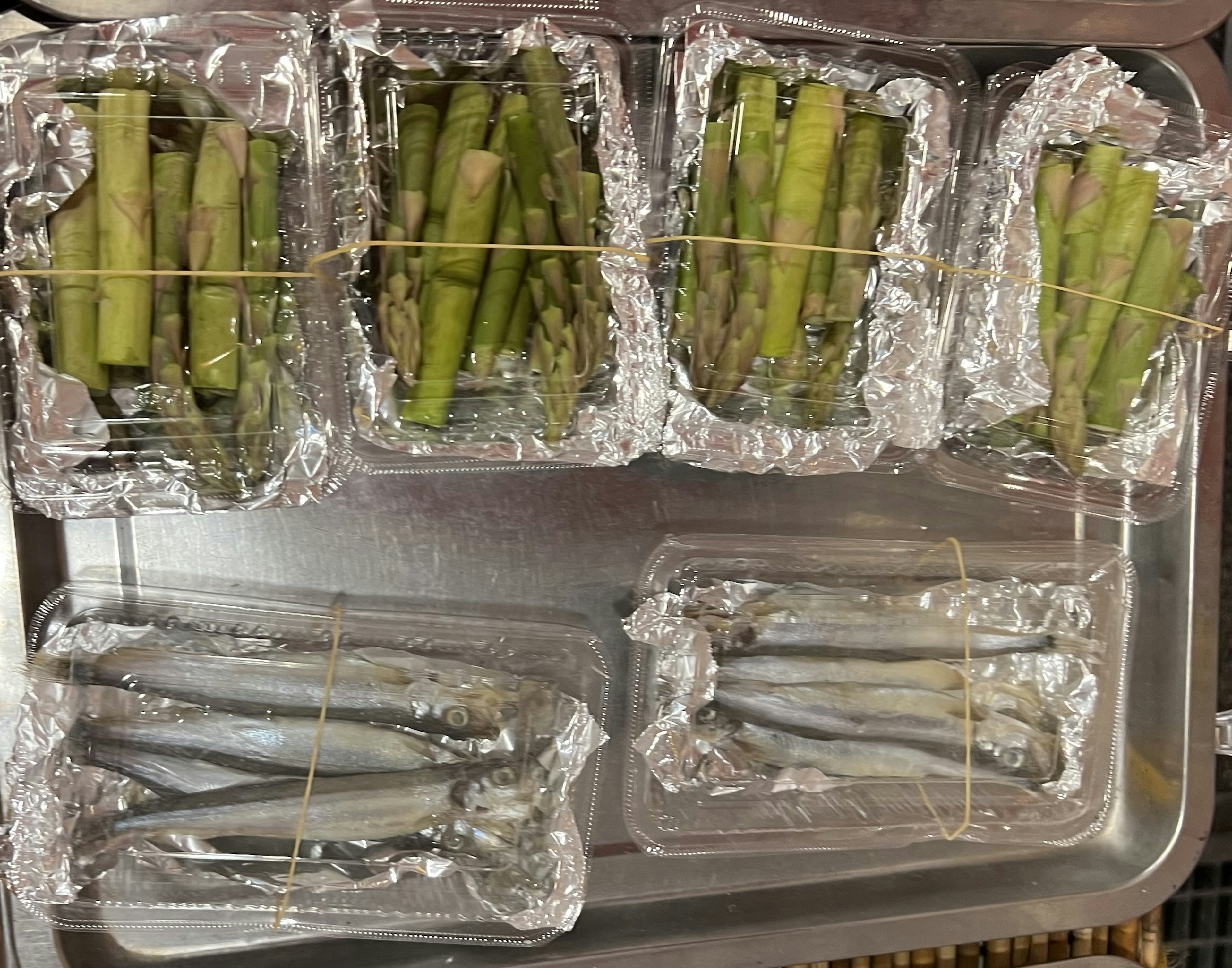 Asparagus and fish arranged on a tray