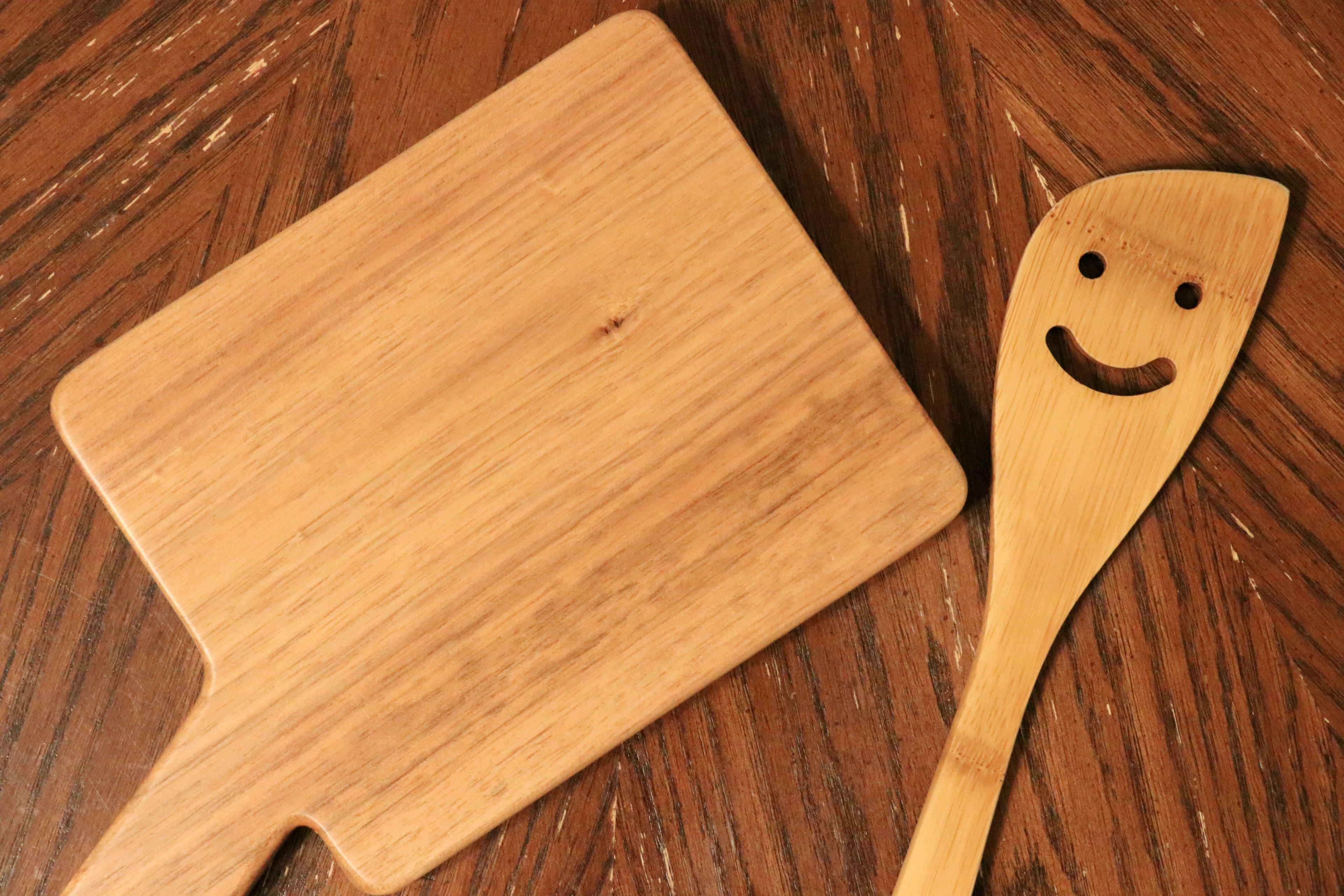 Planche à découper en bois et spatule souriante