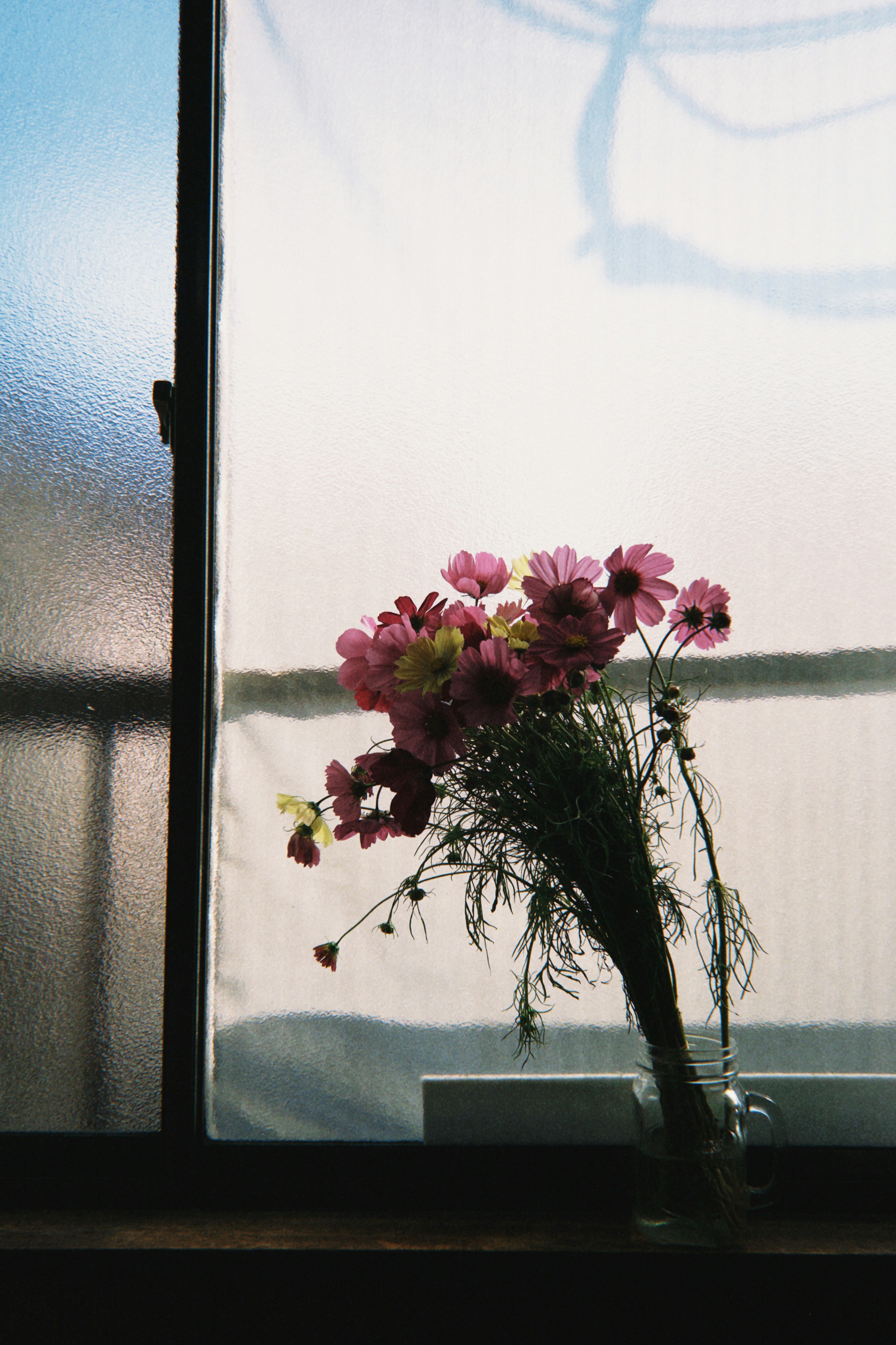 Un bouquet de fleurs près de la fenêtre avec une lumière douce