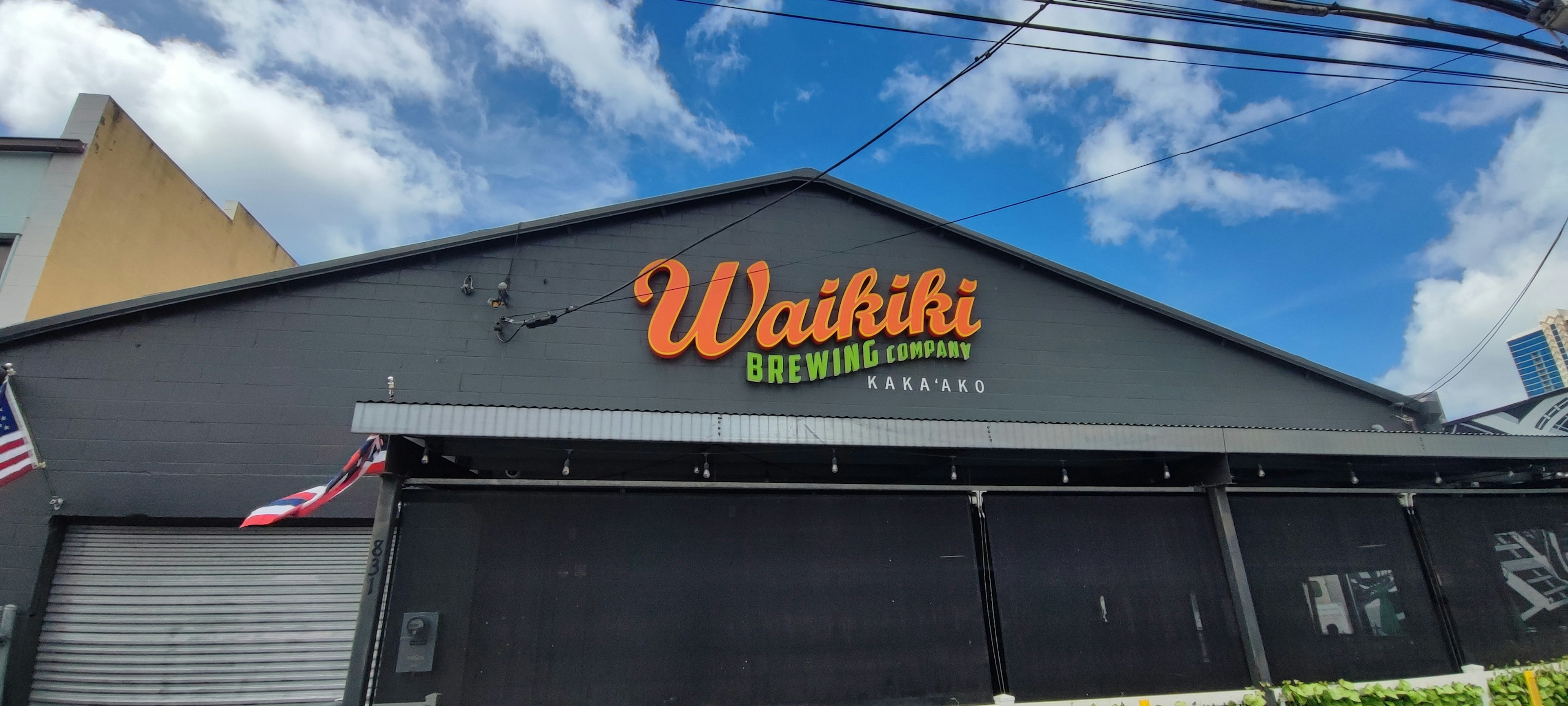 Building with a Hawaiian restaurant sign under blue sky