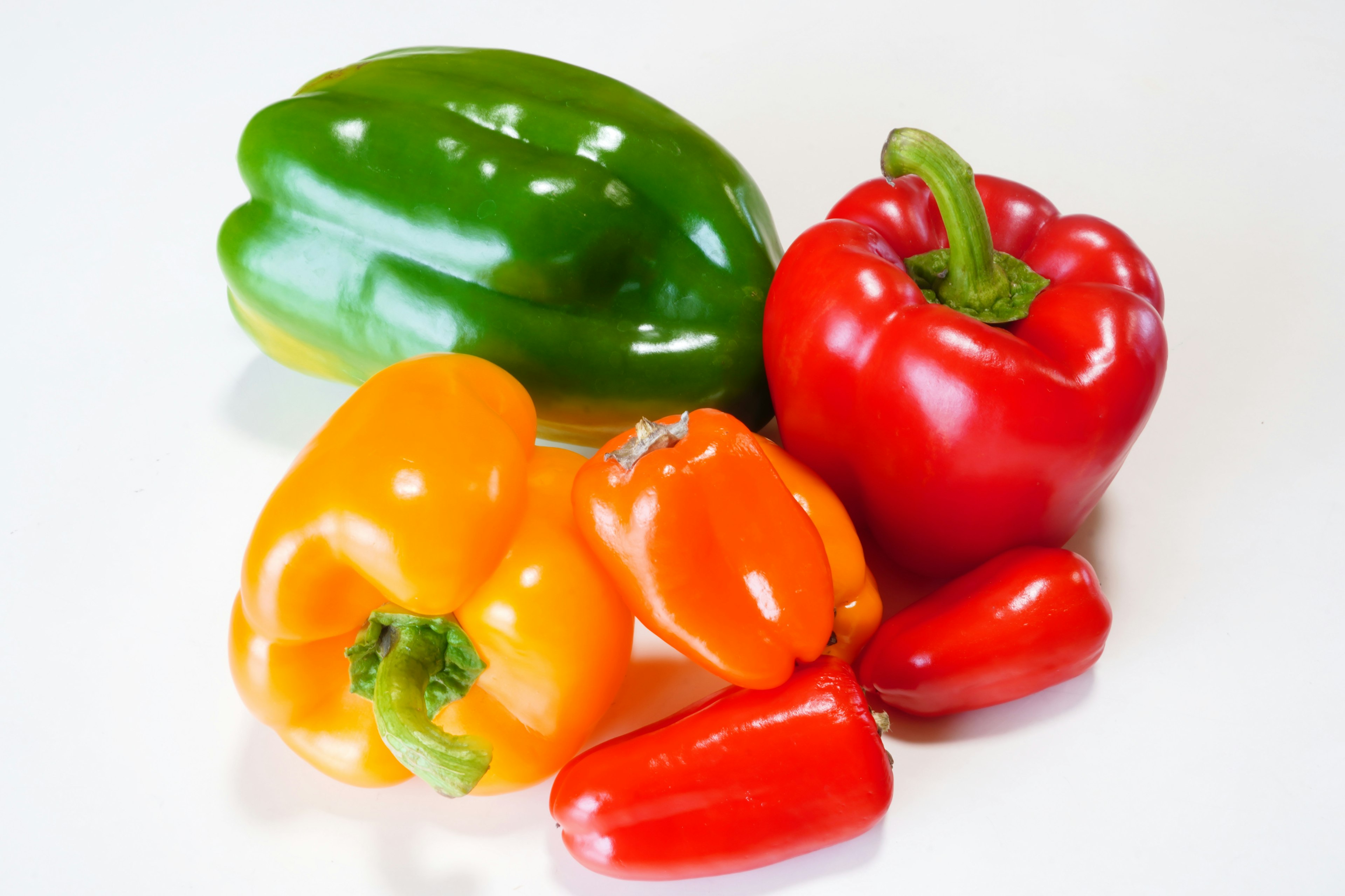 Colorful assortment of bell peppers and small red chili peppers