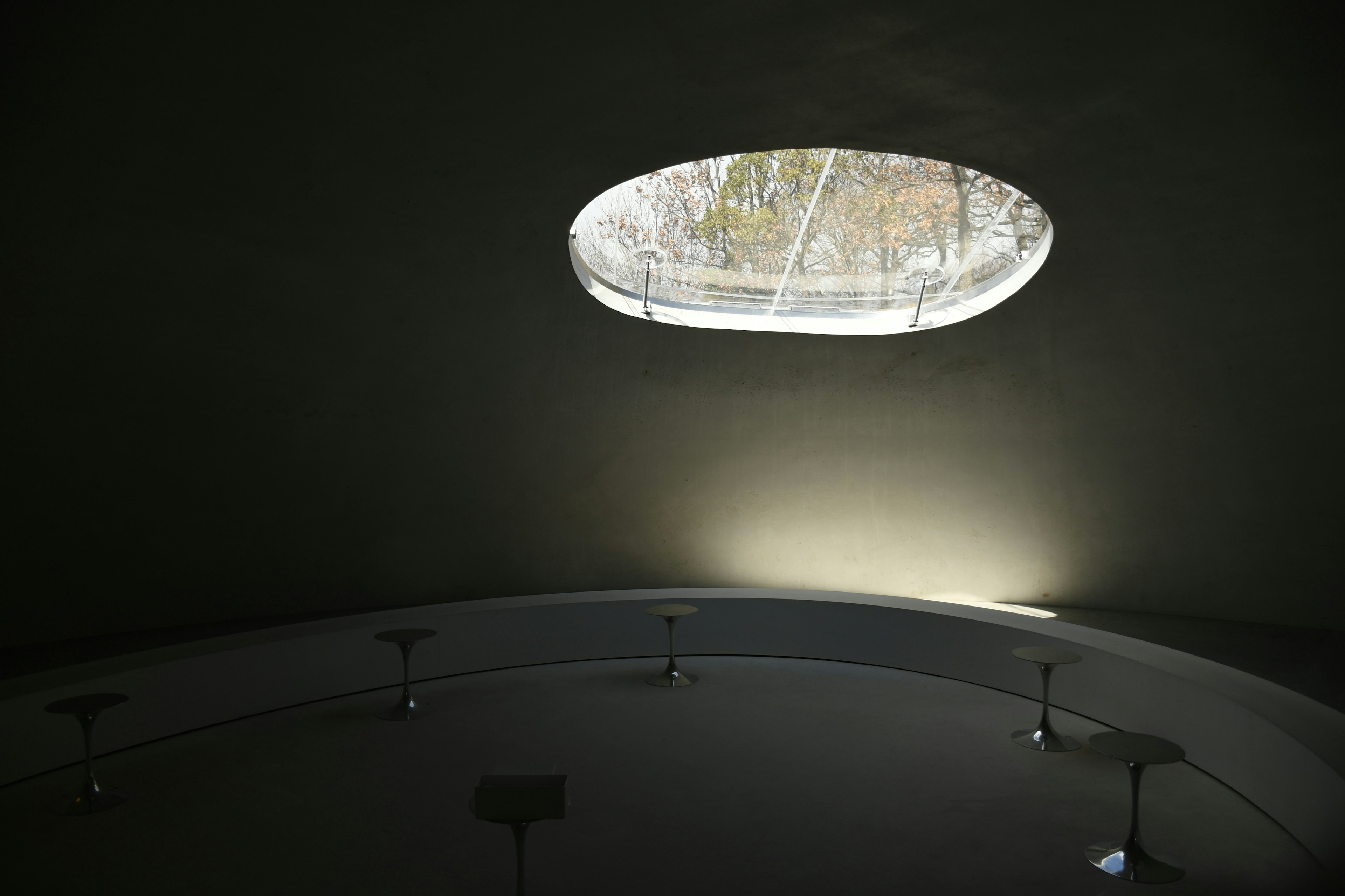 Interior of a modern space with light streaming through an oval window