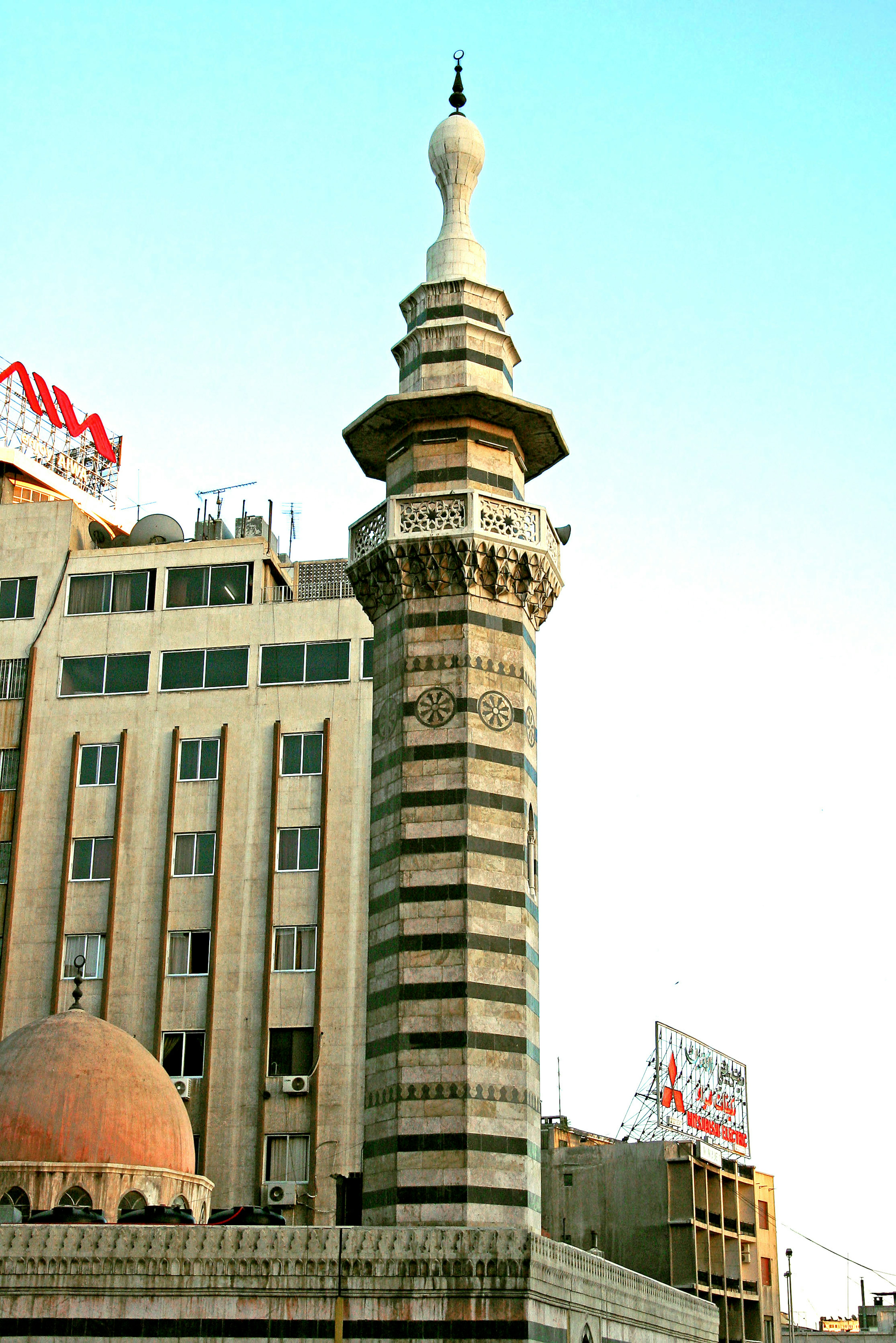 Minaret of a mosque with surrounding buildings