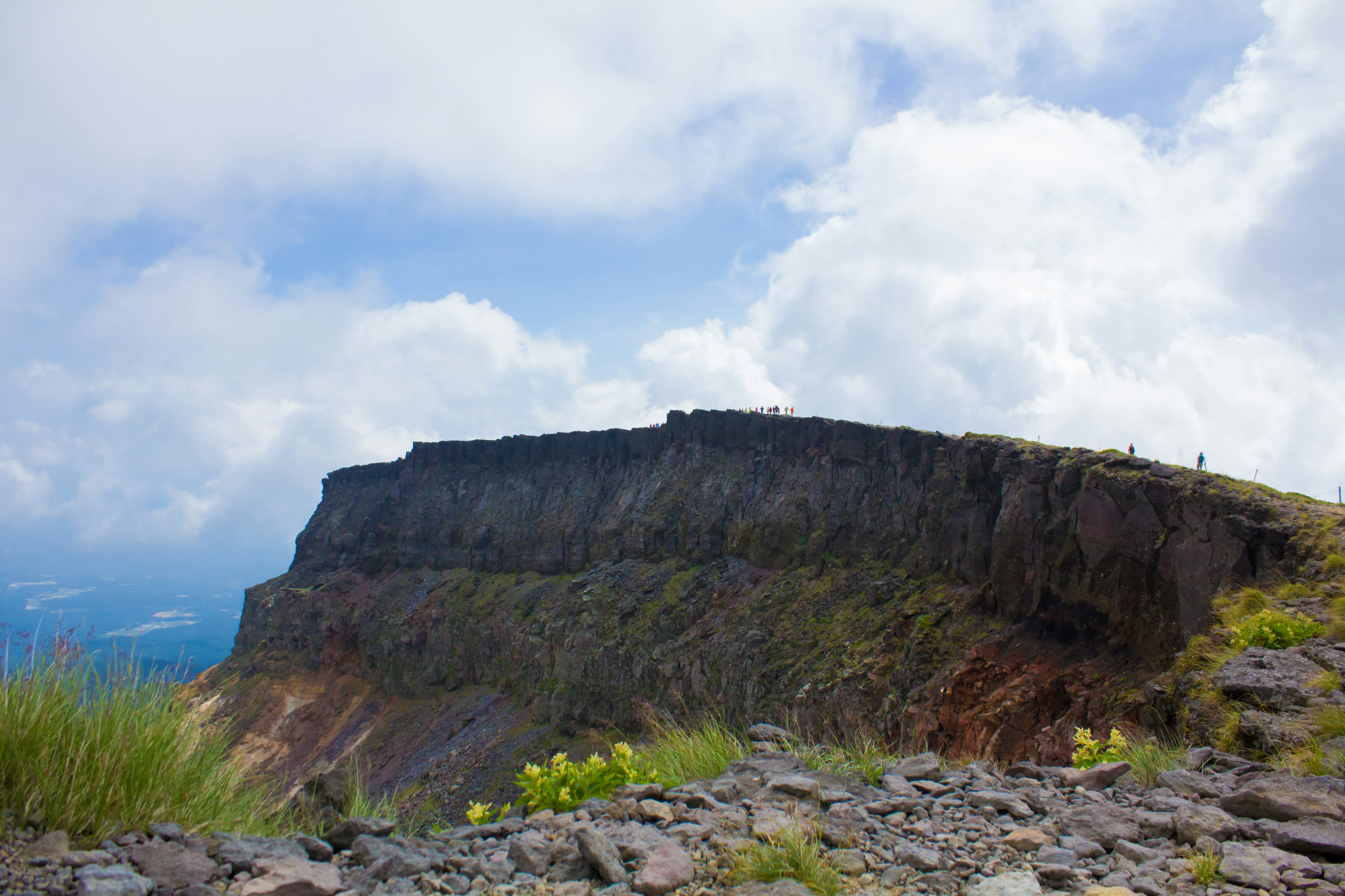 Scenic mountain cliff landscape under a blue sky with clouds