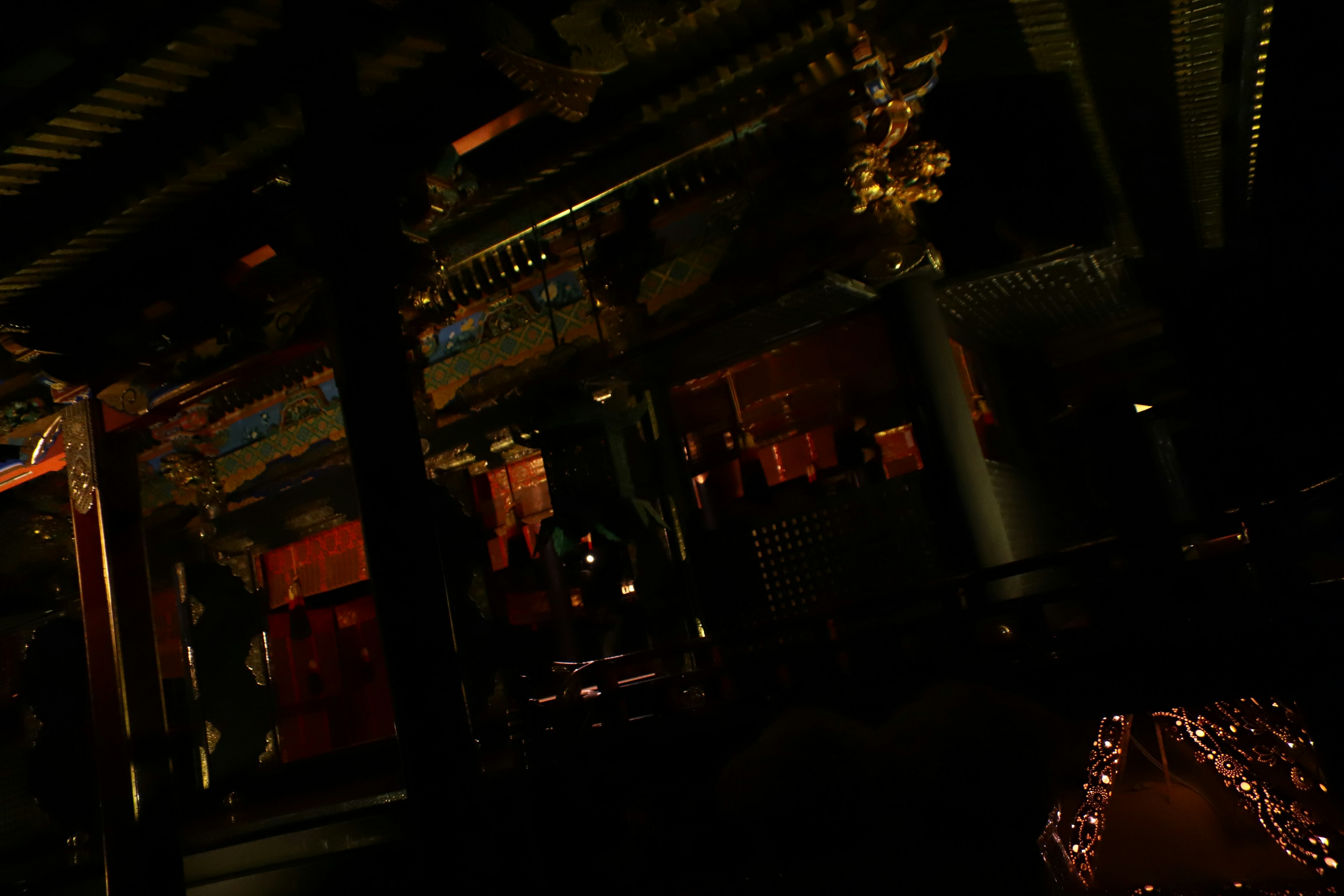 Dimly lit interior featuring ornate ceiling and pillars