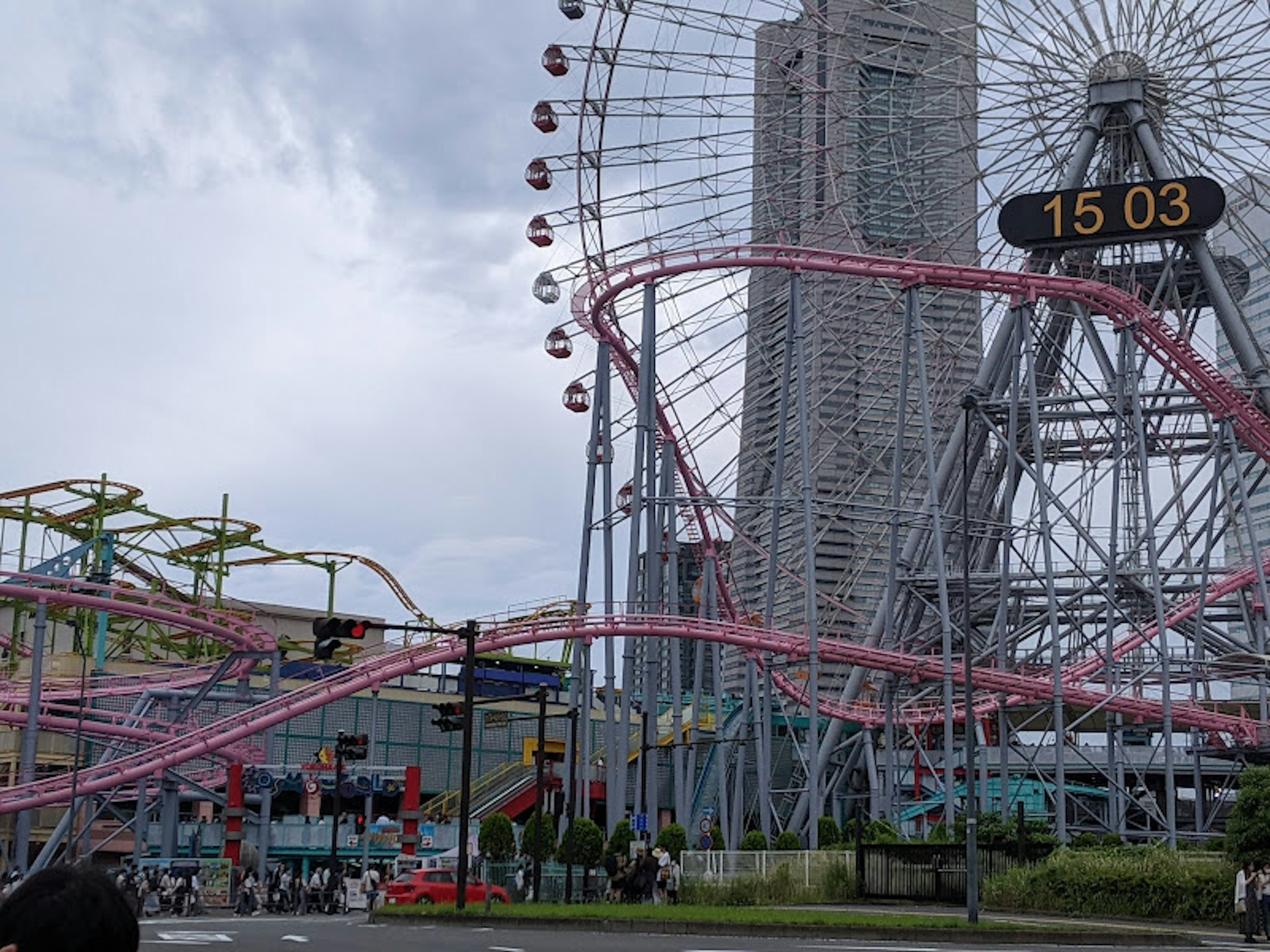 Amusement park scene featuring a Ferris wheel and roller coaster