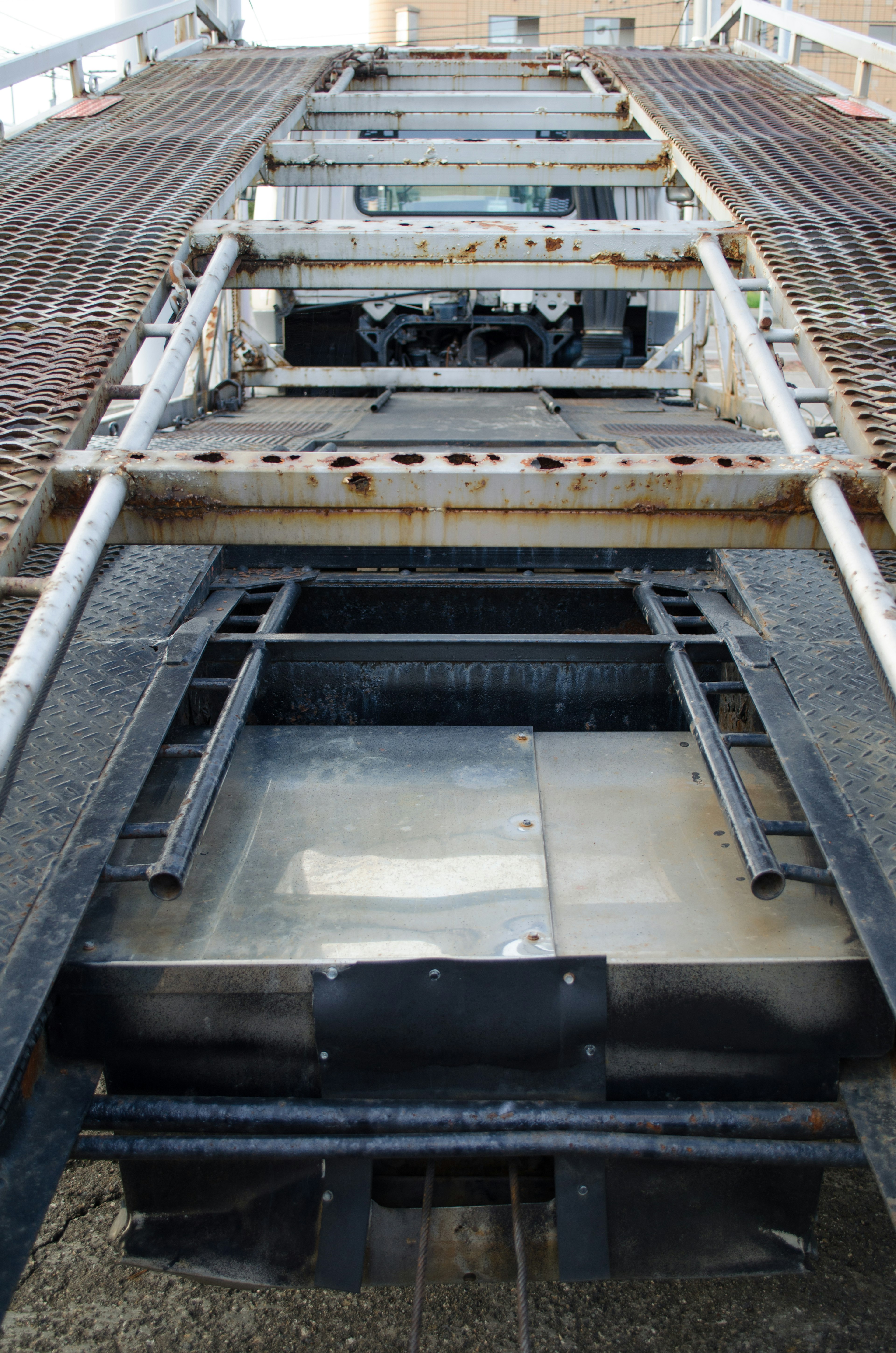 Top view of a metal structure featuring a smooth surface with numerous holes