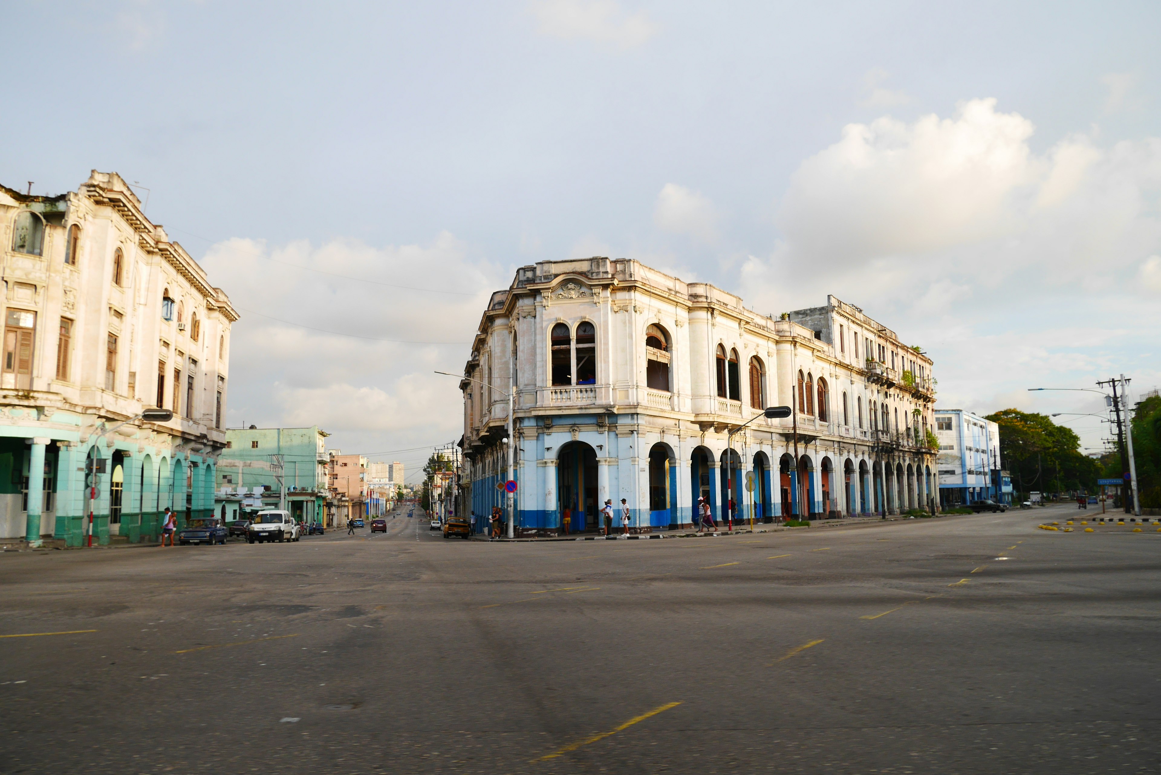 Quiet street scene with old buildings and a partially cloudy sky