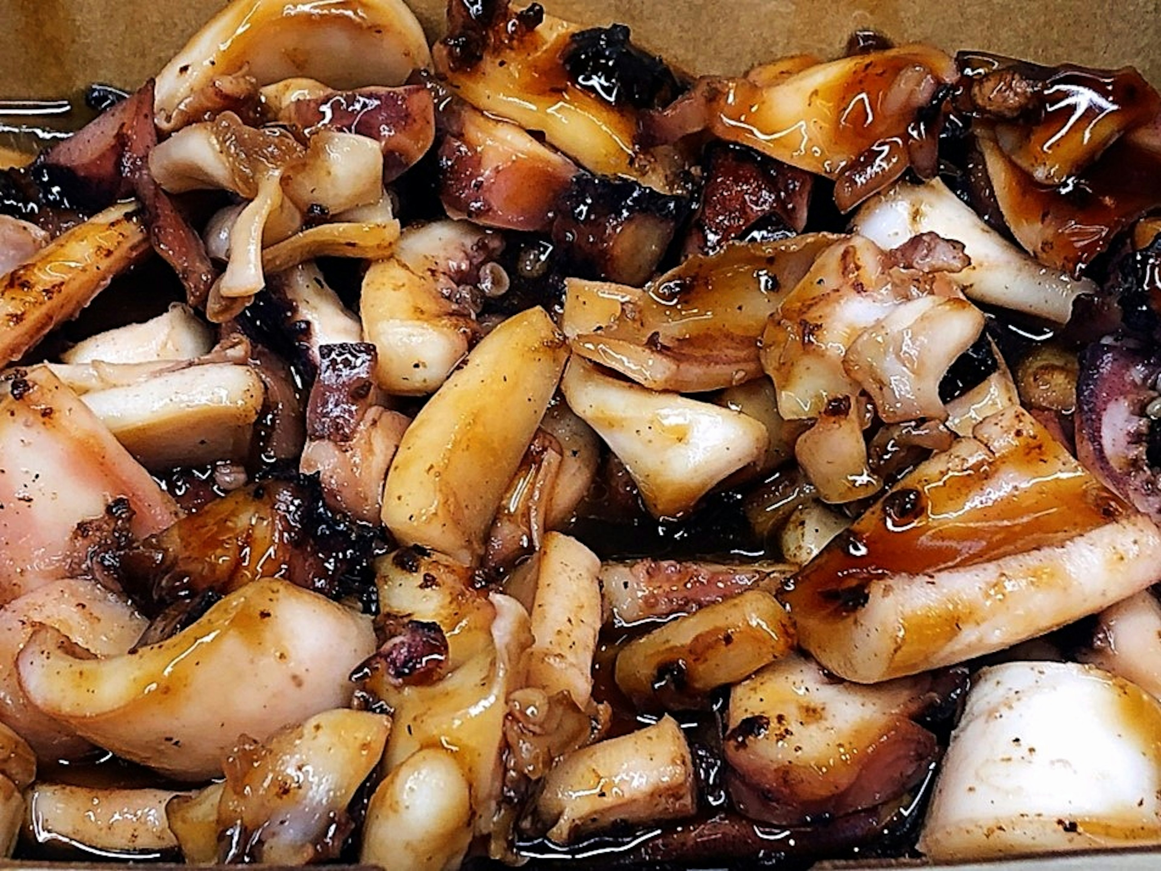 A dish featuring a generous portion of grilled squid pieces