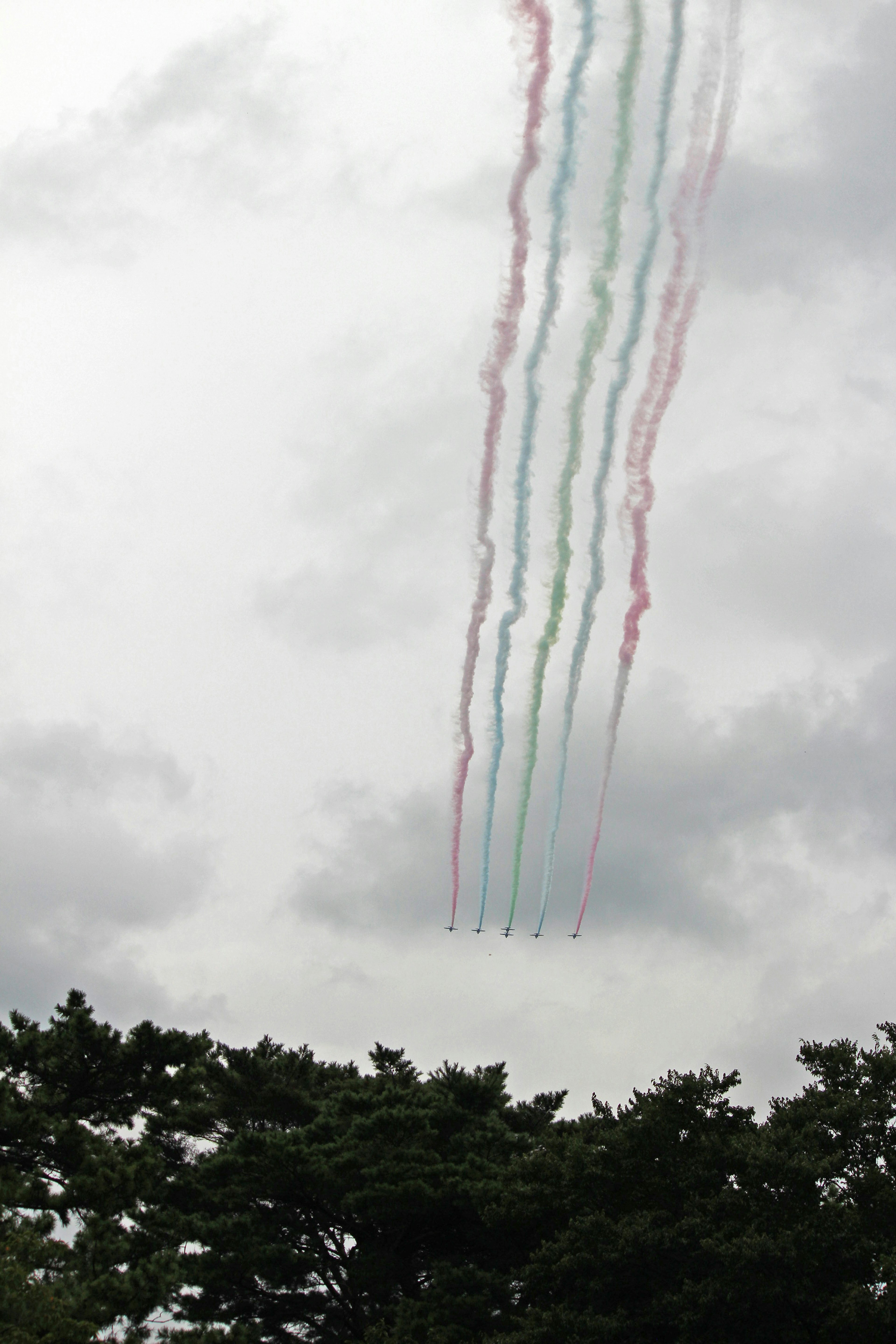 Colorful smoke trails in the sky with blue red and green stripes