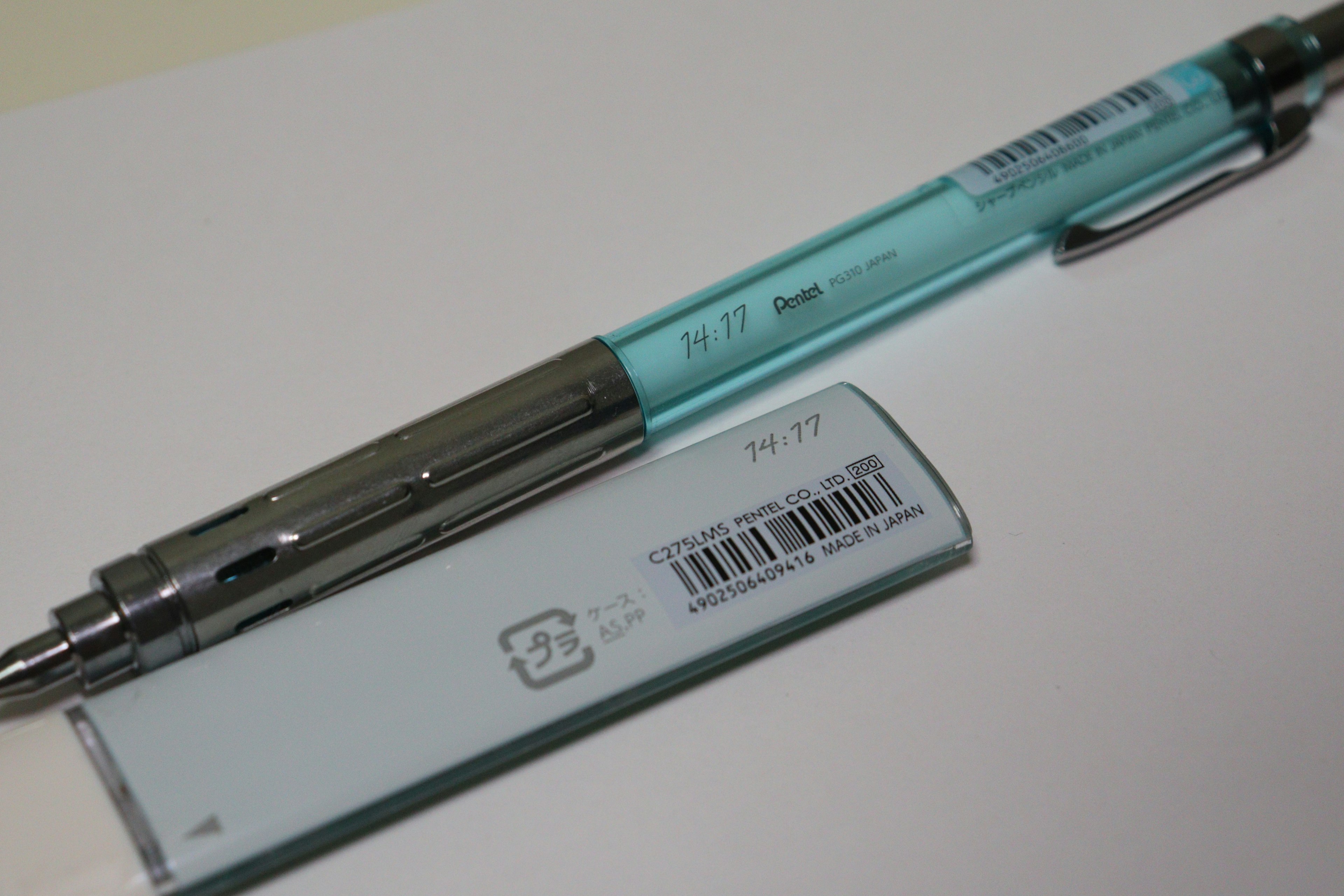 A blue ballpoint pen and a white eraser are displayed