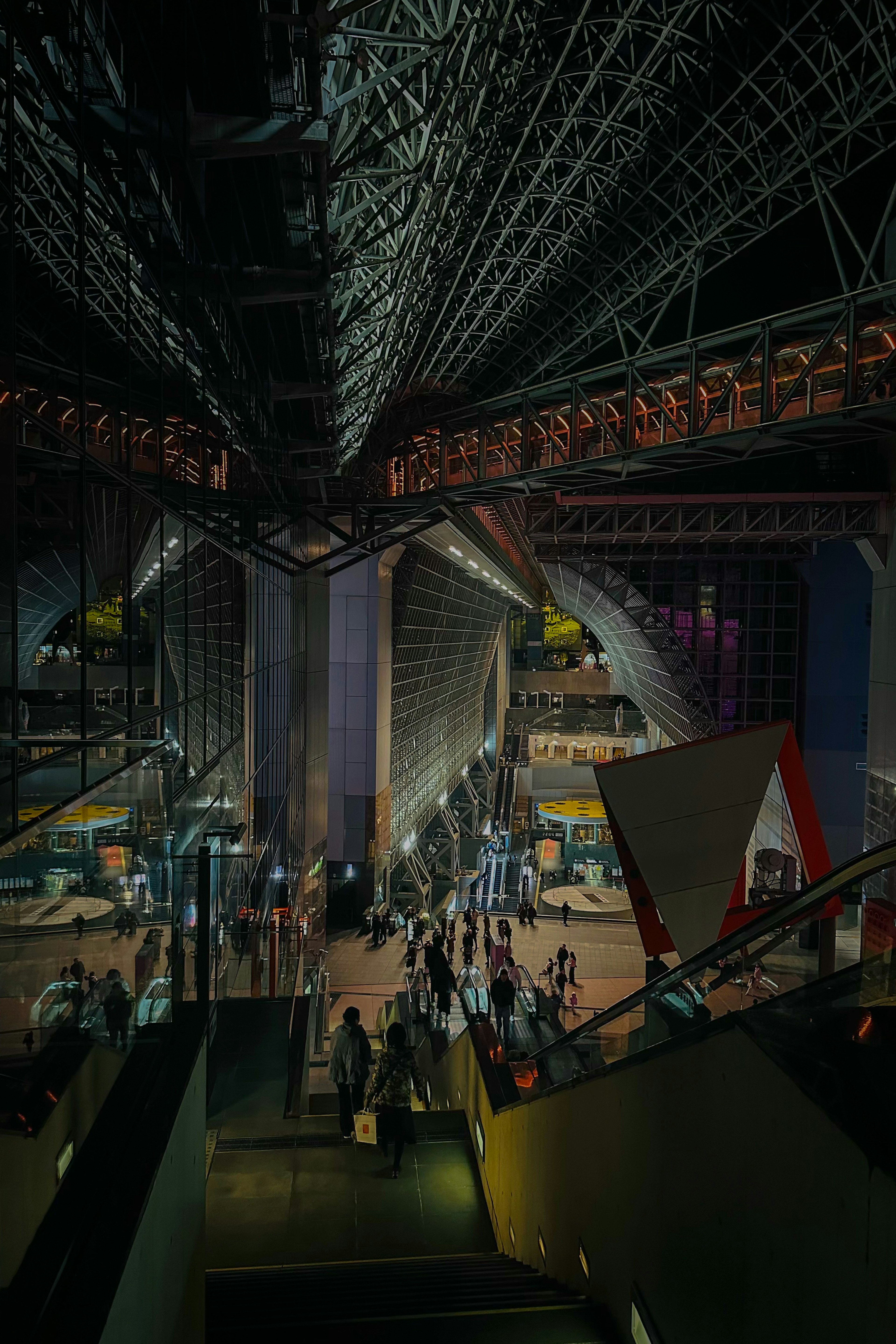 Interior of a modern building with many people gathered impressive lighting and structural design