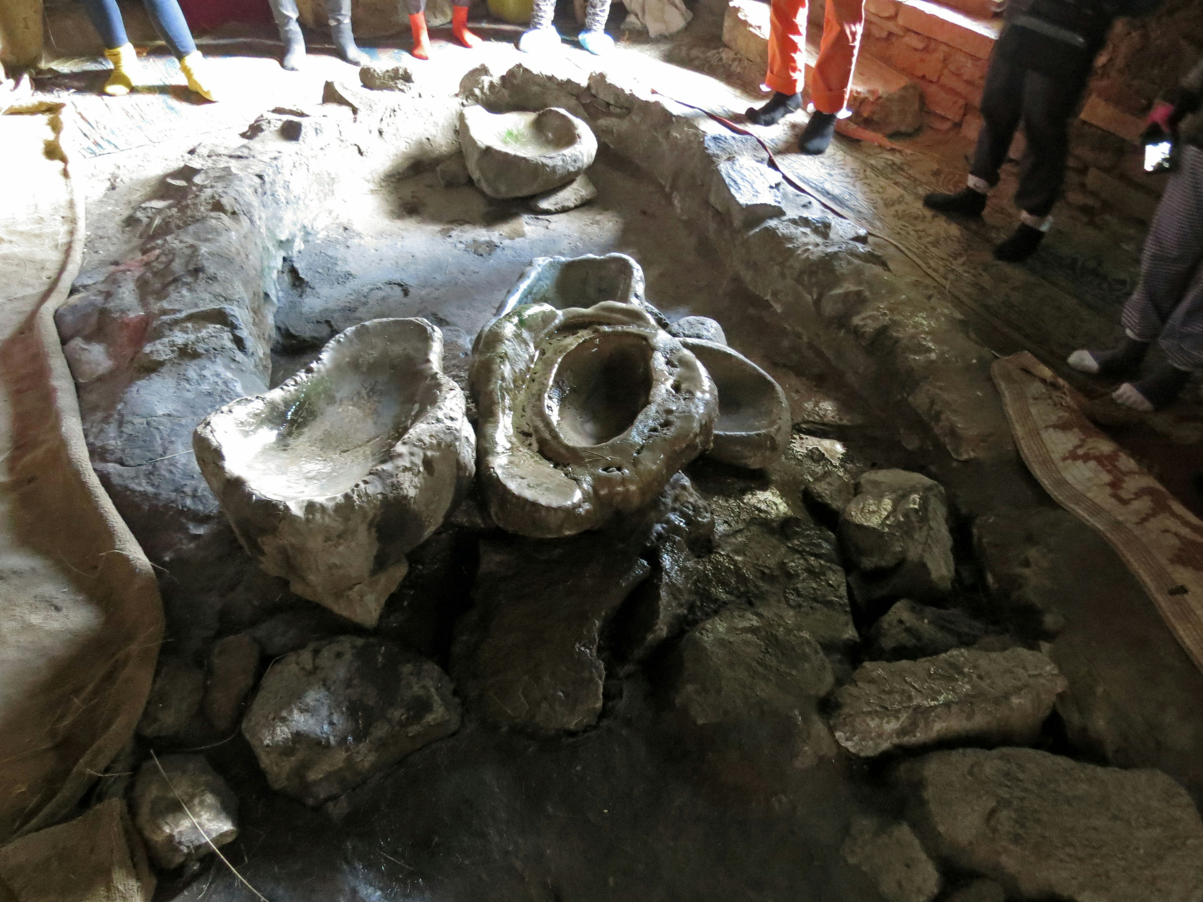 Group of people gathered around archaeological artifacts