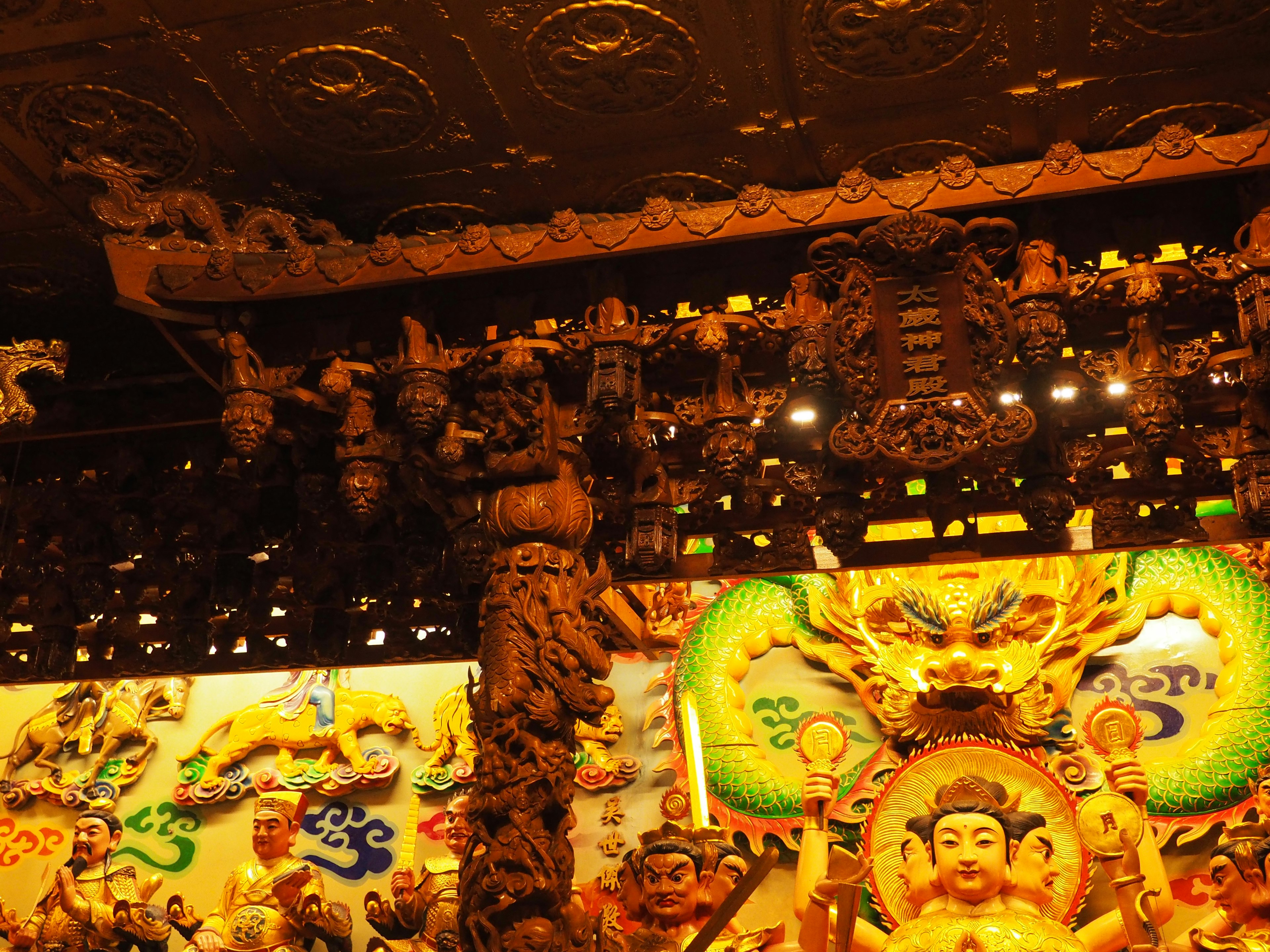 Colorful Buddha statue and intricate decorations inside a temple